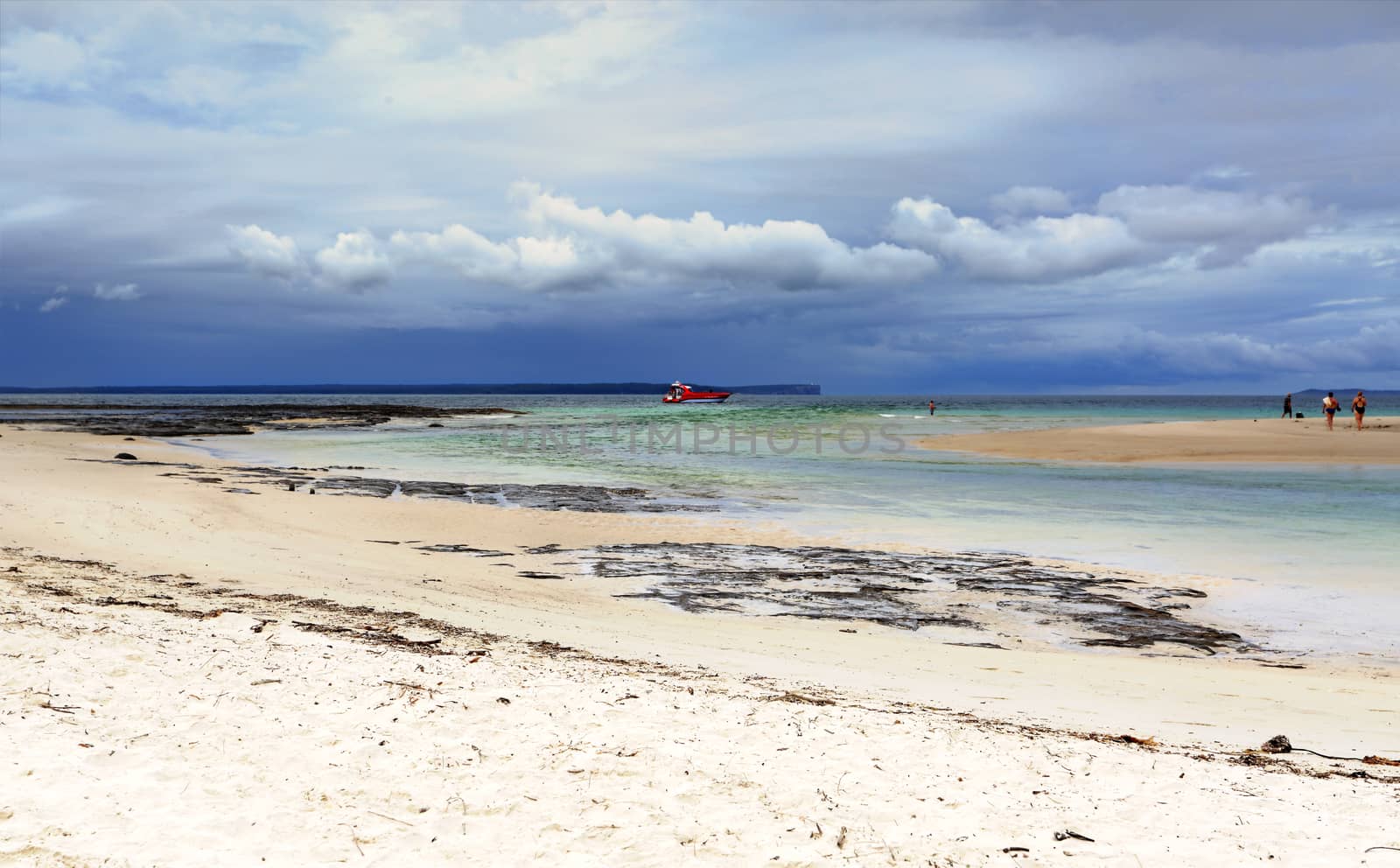 Moona Moona Creek flowing out to the ocean at Huskisson as storm clouds roll in from the east.