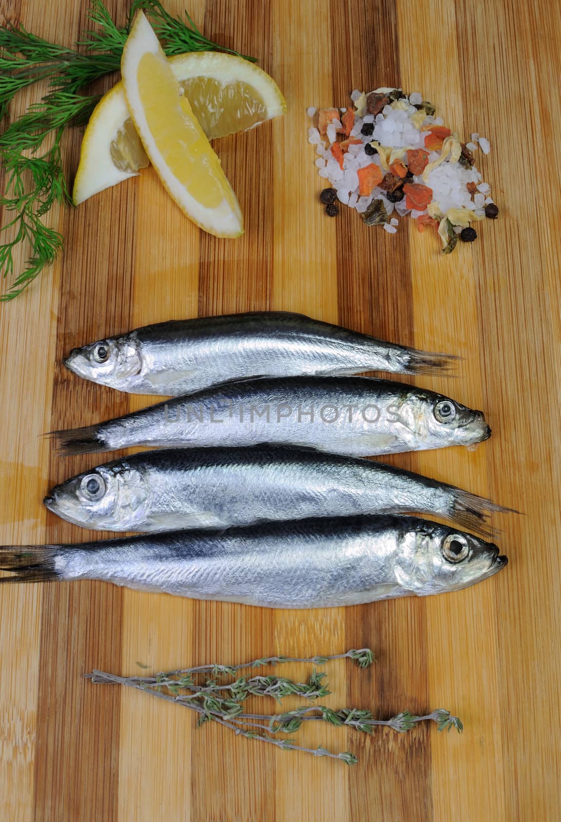 sprat with salt and spices on the board