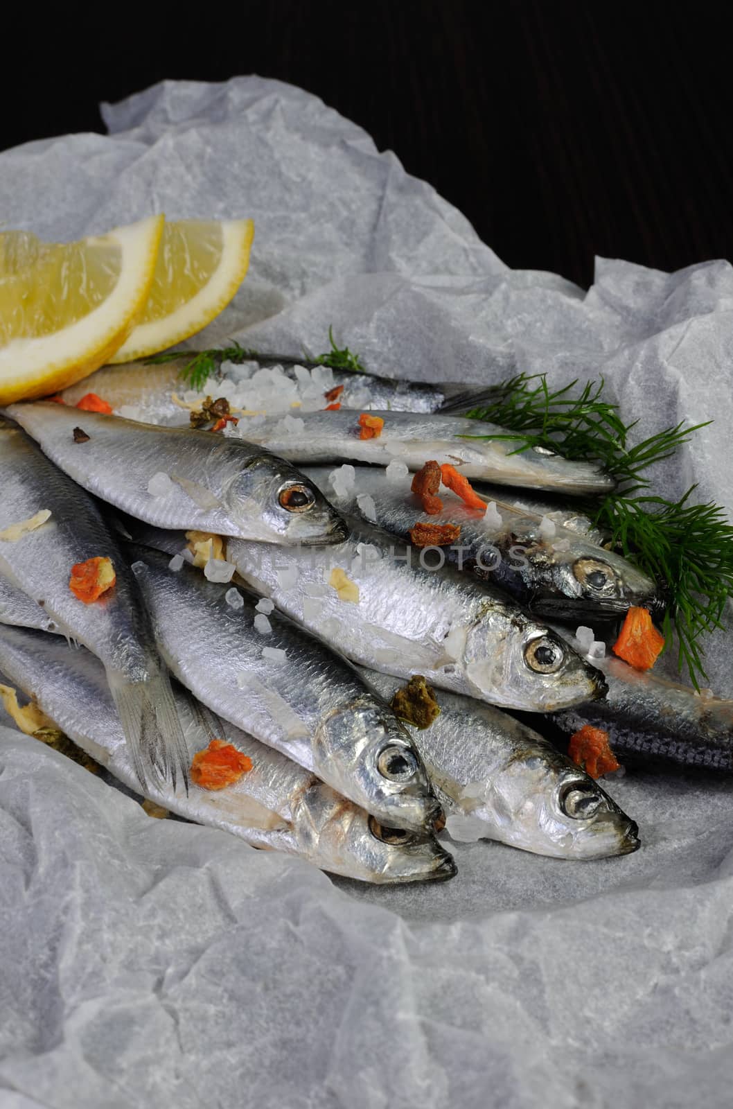 sprat with salt and spices in parchment