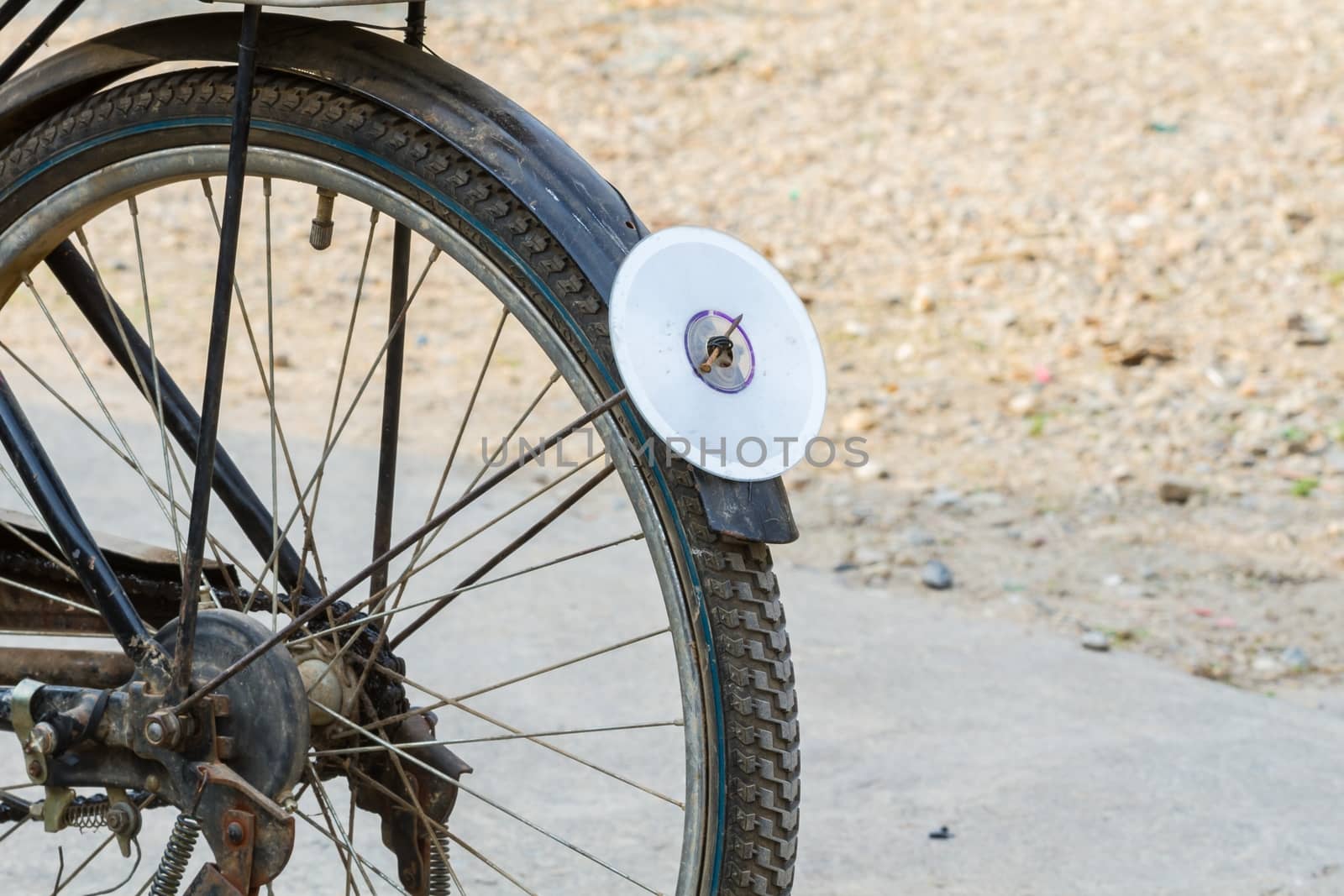 cd disc on rear mudguard of bicycle, used as reflector by a3701027