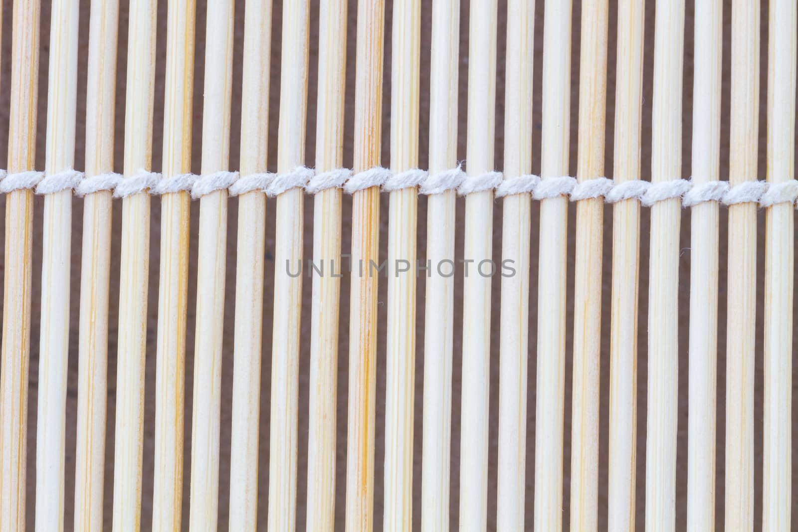 Close up macro of beige brown bamboo mat as striped background texture pattern. Oriental.