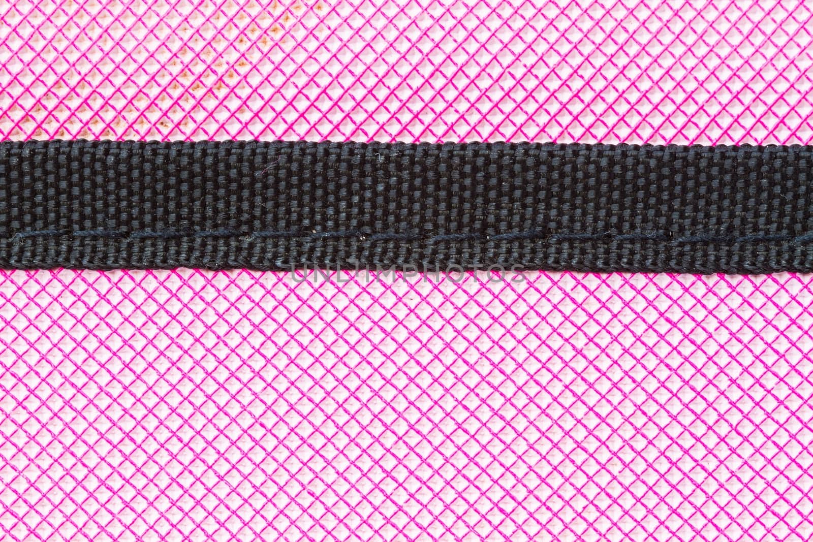 close-up pink soft case of tablet as background and texture, with black stripe