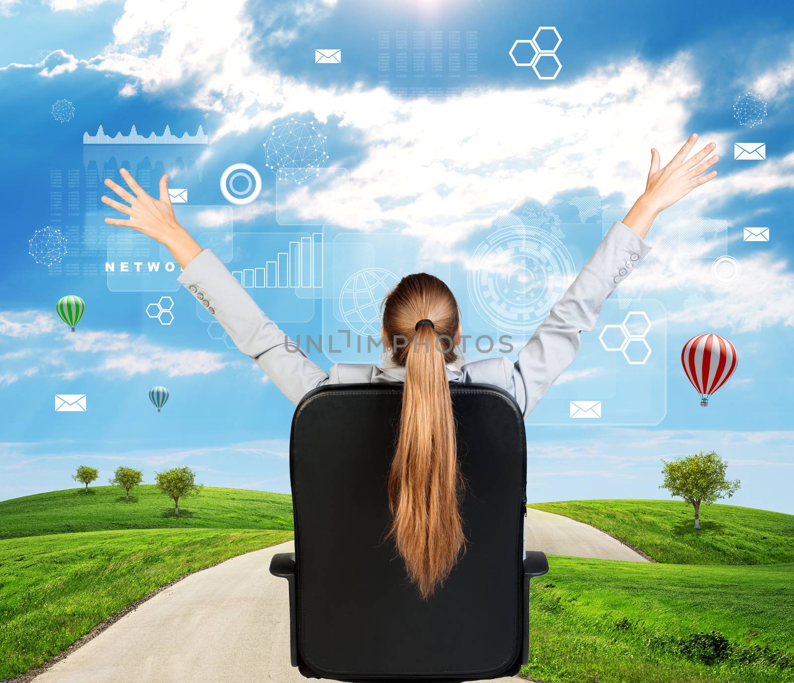 Businesswoman sitting on office chair with her hands outstretched. Green hills with sky and virtual elements as backdrop