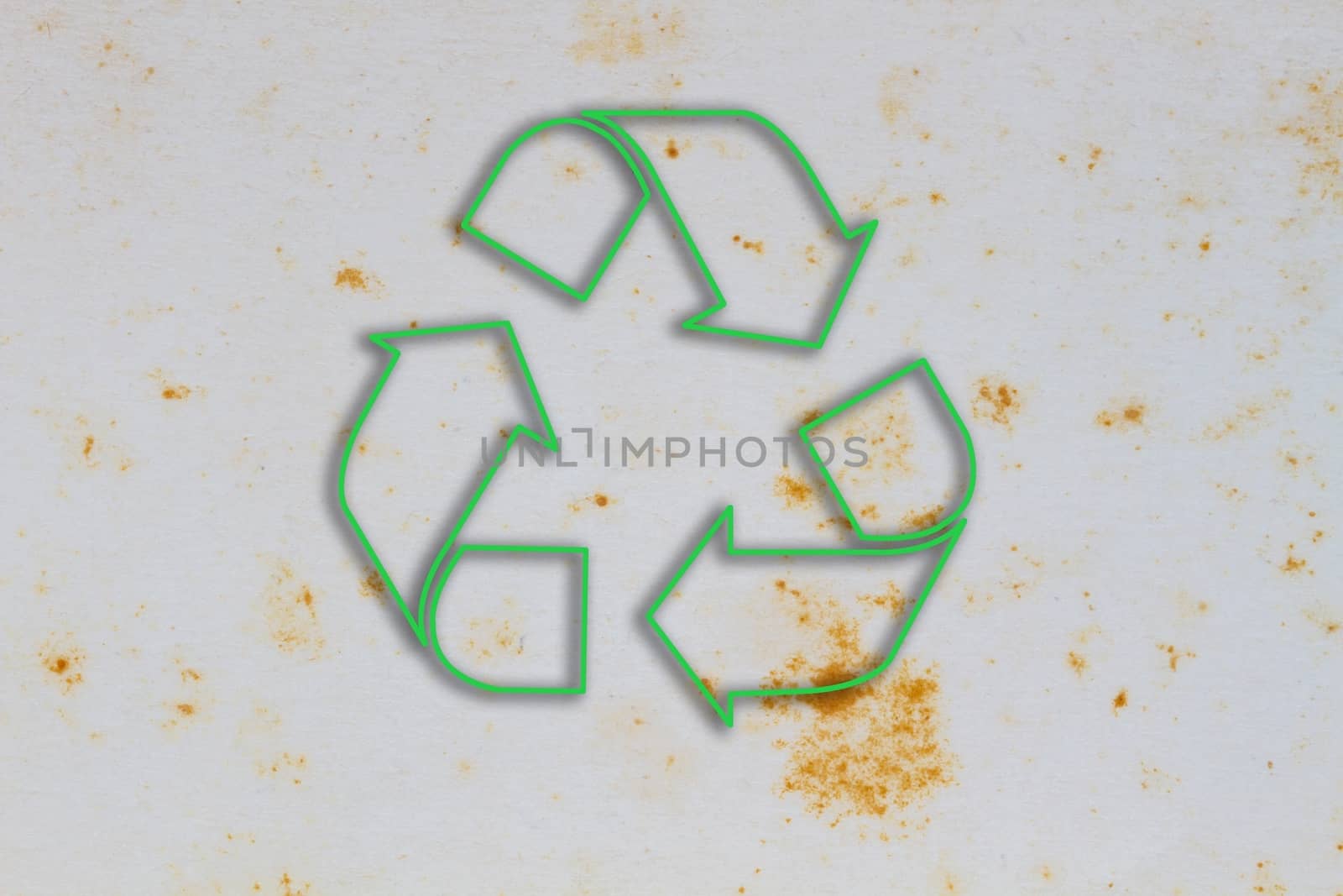 Old vintage paper with coffee stain in the middle, with green sign of recycle