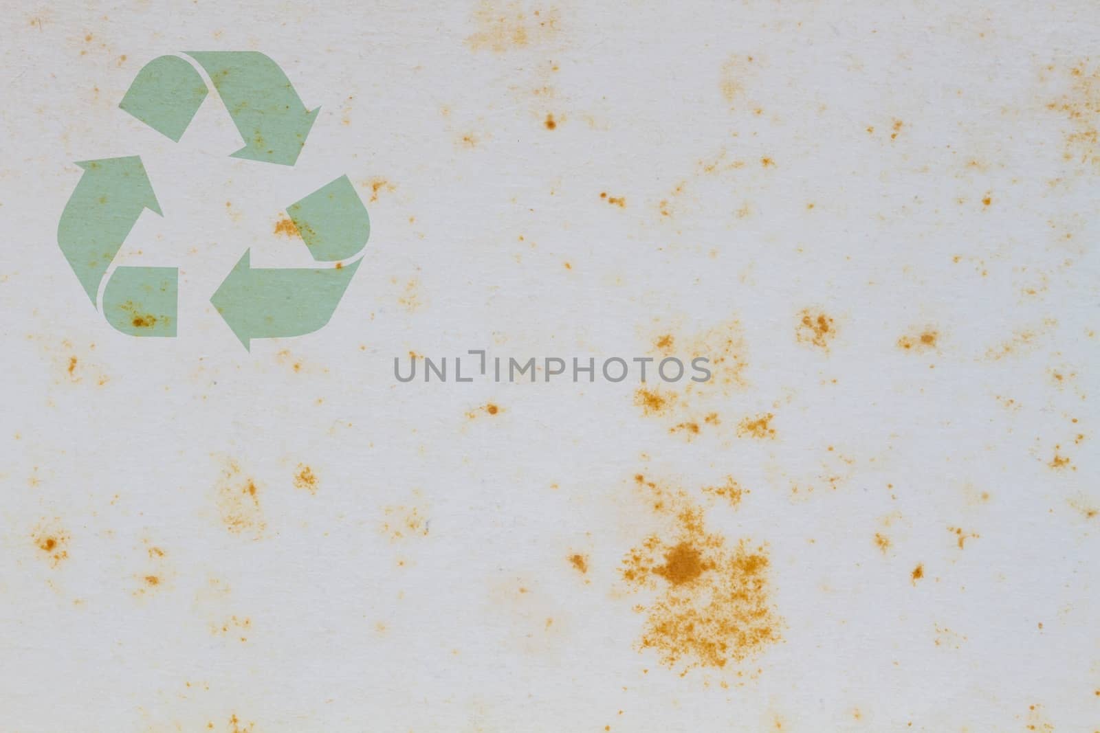 Old vintage paper with coffee stain in the middle, with symbol of recycle on the upper corner