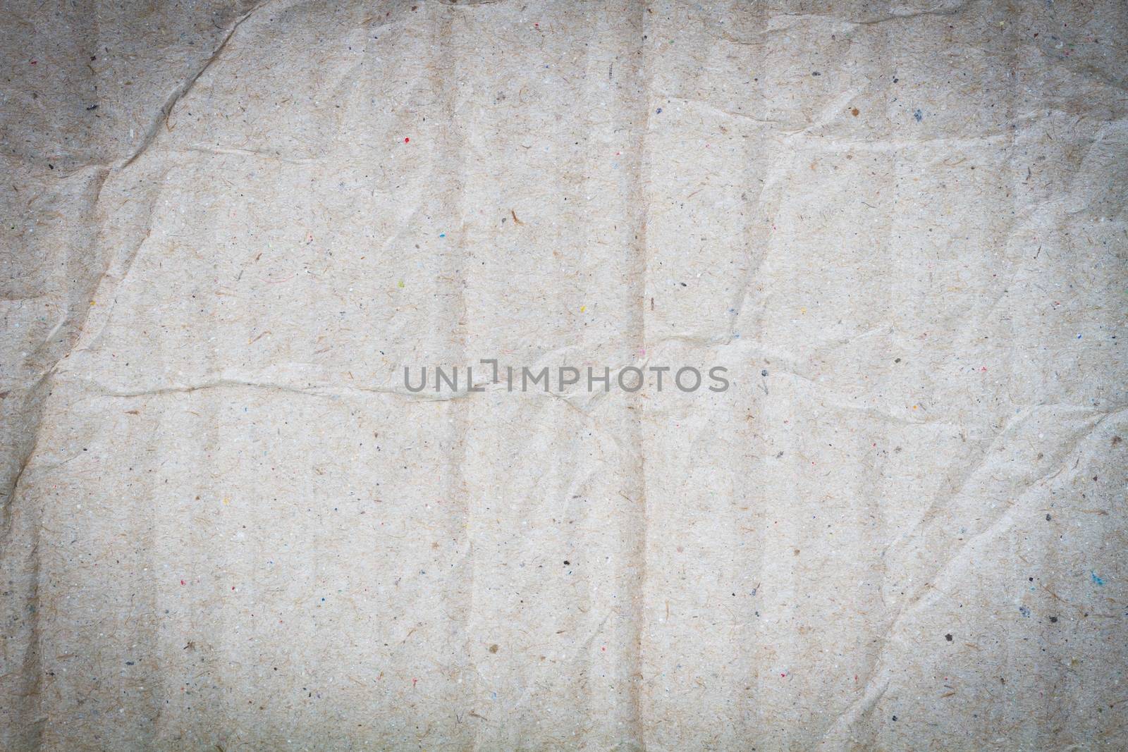 background of crumpled grey cardboard with texture, vignette