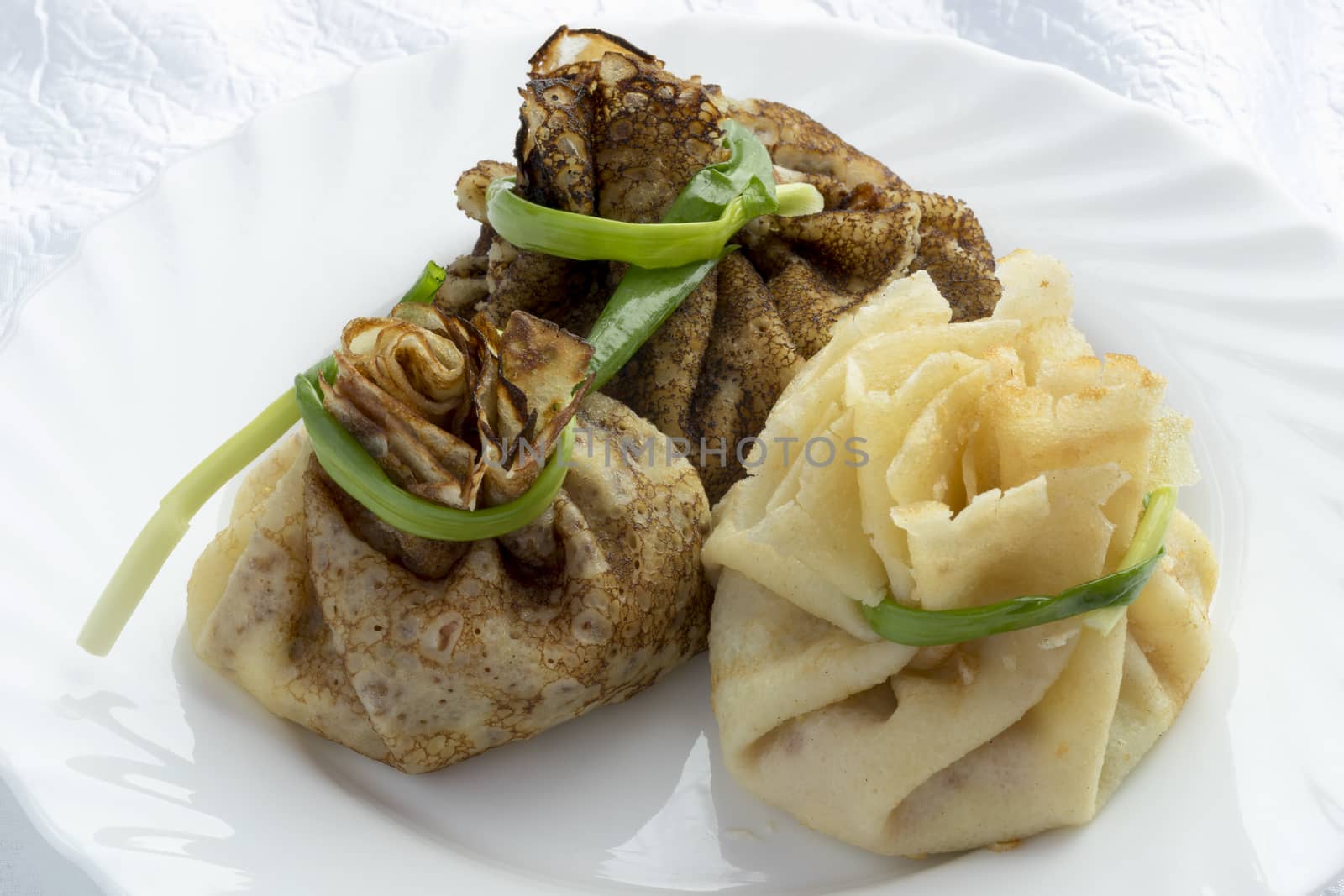 Blind with ham ,cheese and pickles tied green onions.