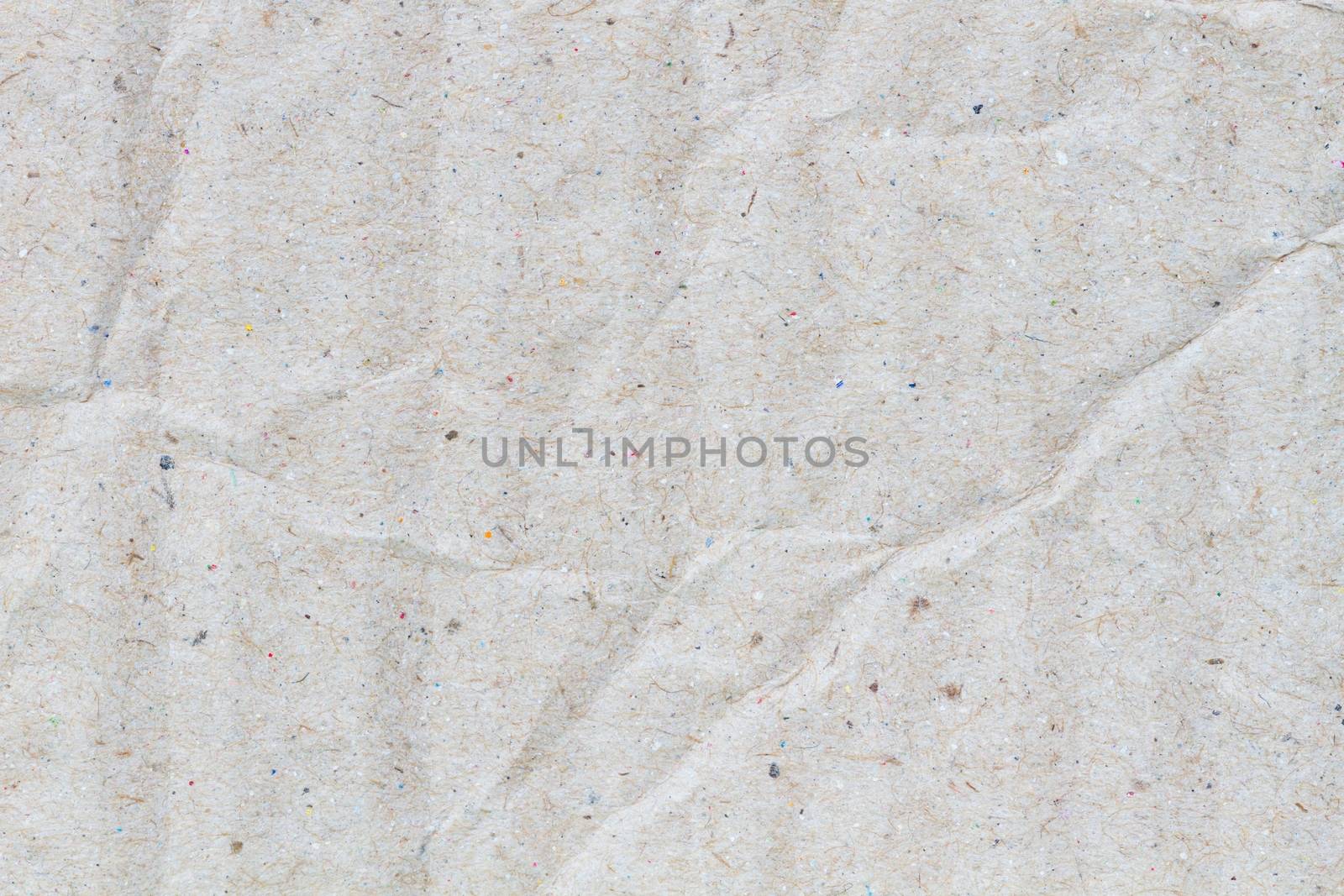 macro of crumpled grey cardboard paper as background with texture