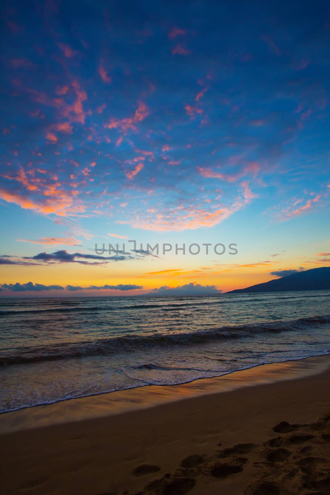 Sunset and beach footprints on Maui in Hawaii