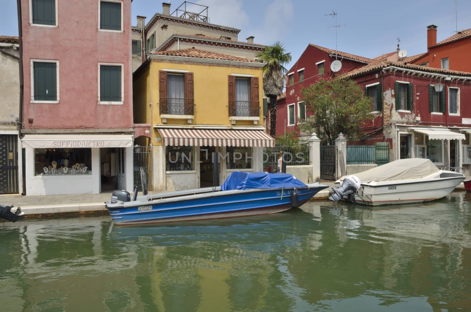 Boats parken on a small canal in Murano, an island in the Venetian Lagoon, northern Italy.