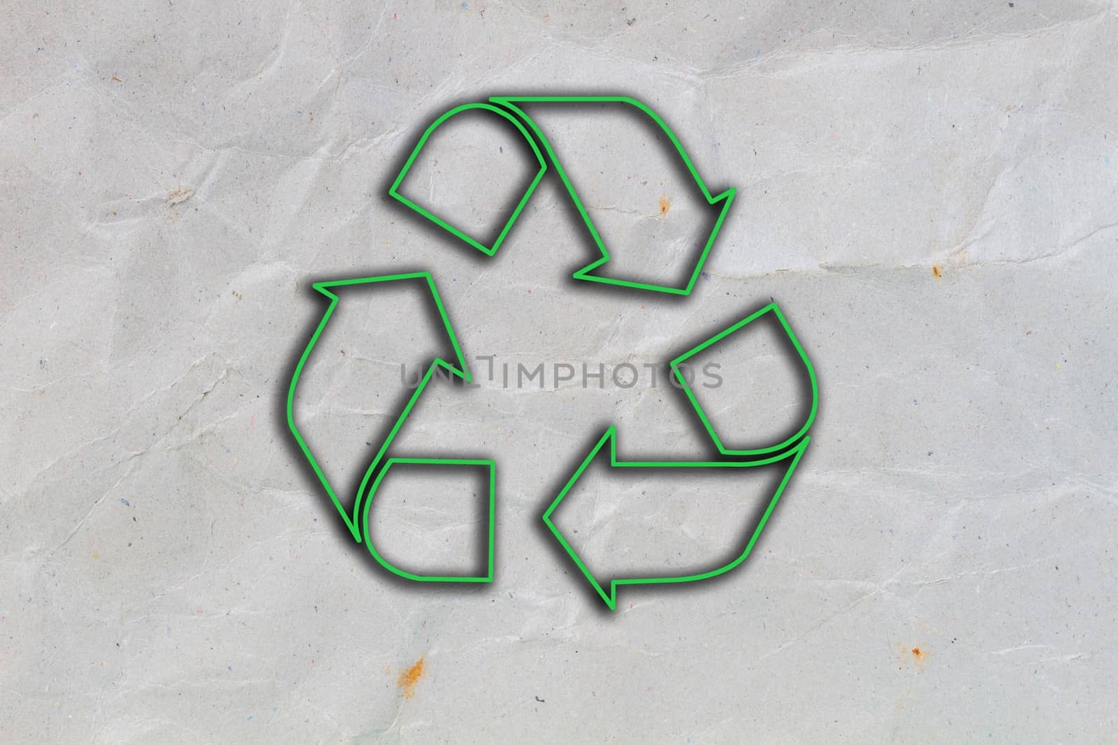 crumpled grey cardboard with background and texture, with green sign of recycle
