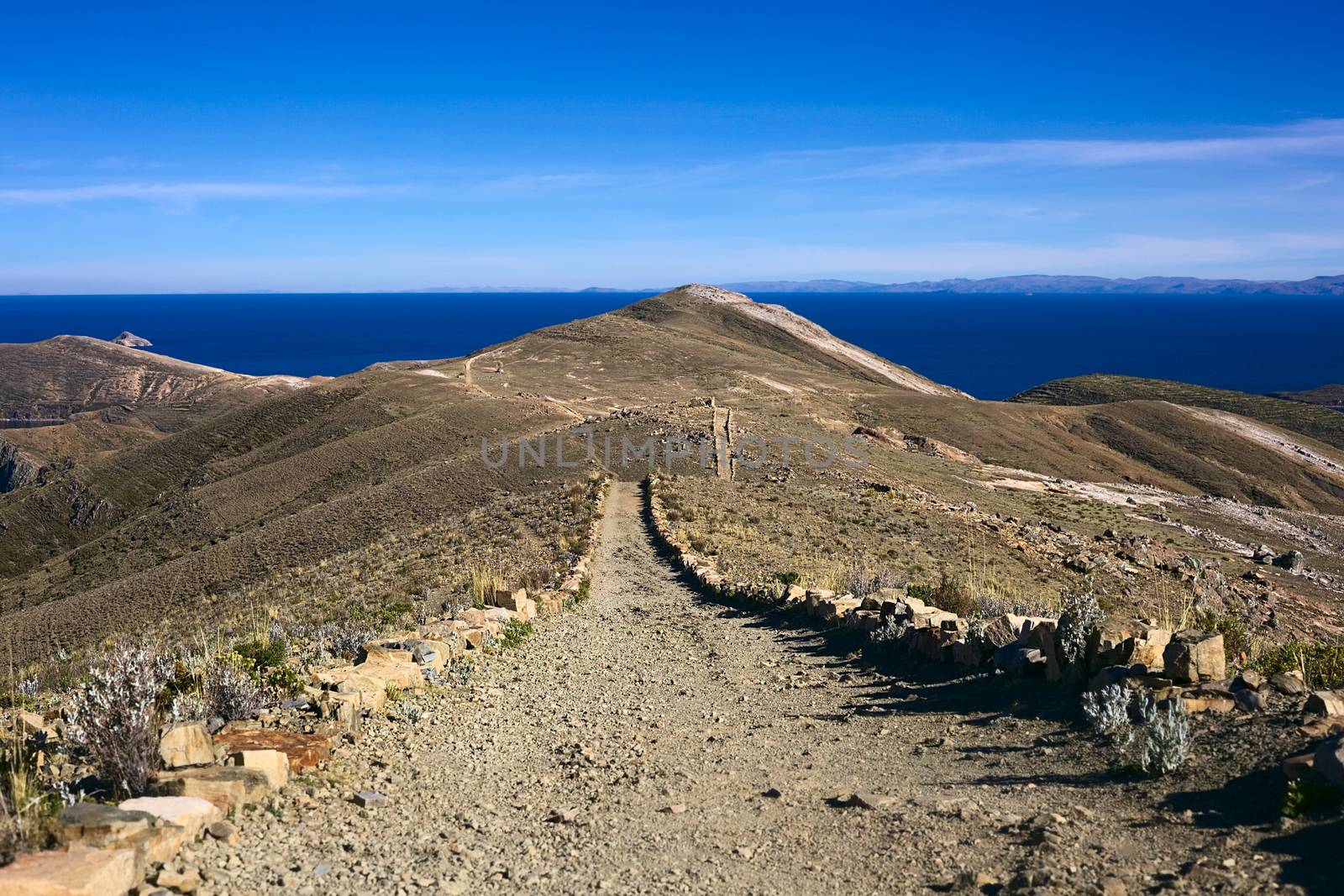 Path leading on ridge on Isla del Sol, Lake Titicaca, Bolivia. Isla del Sol (Island of the Sun) is a popular travel destination. 