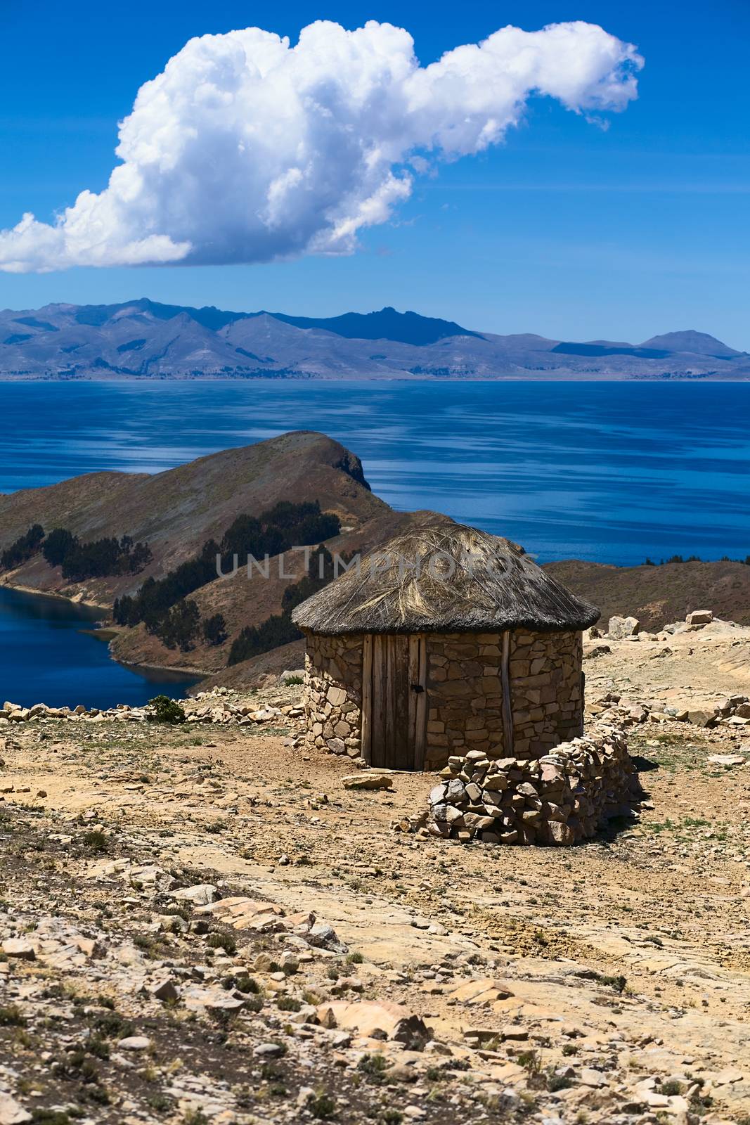 Small stone hut with thatched roof on Isla del Sol (Island of the Sun) in Lake Titicaca, Bolivia. The island is a popular tourist destination. 