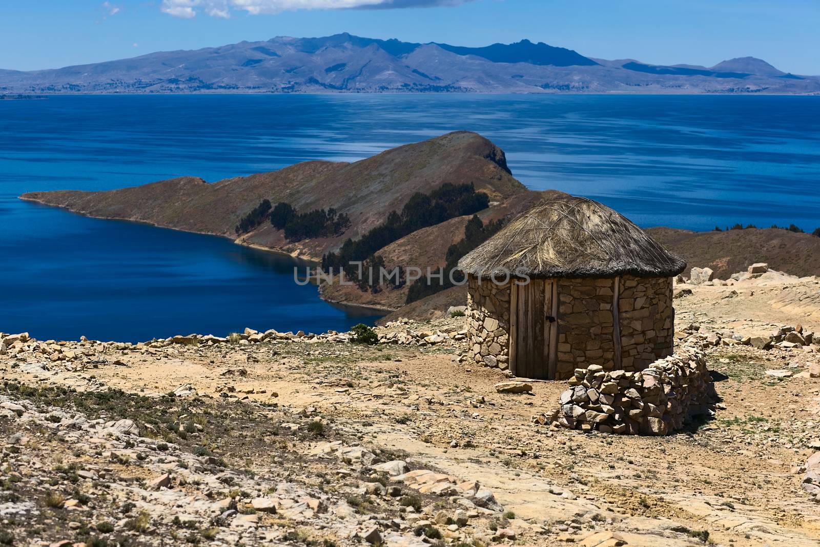 Small round stone hut with thatched roof on Isla del Sol (Island of the Sun) in Lake Titicaca, Bolivia. The island is a popular tourist destination. 