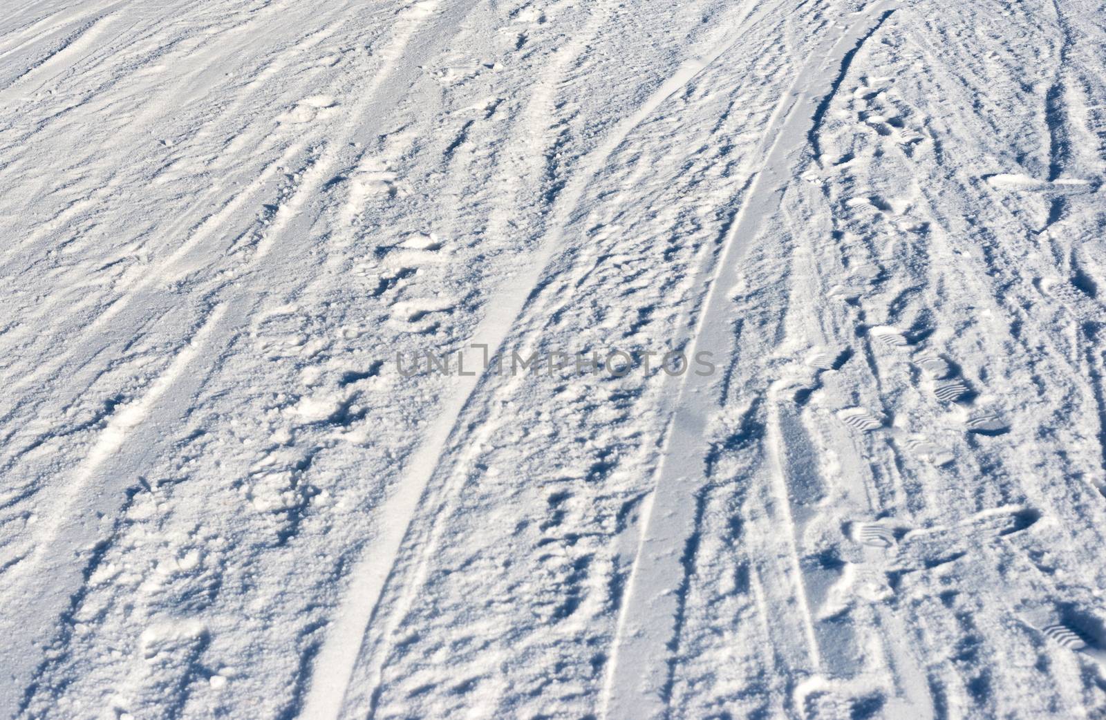 Closeup photo of skis marks on snow slope