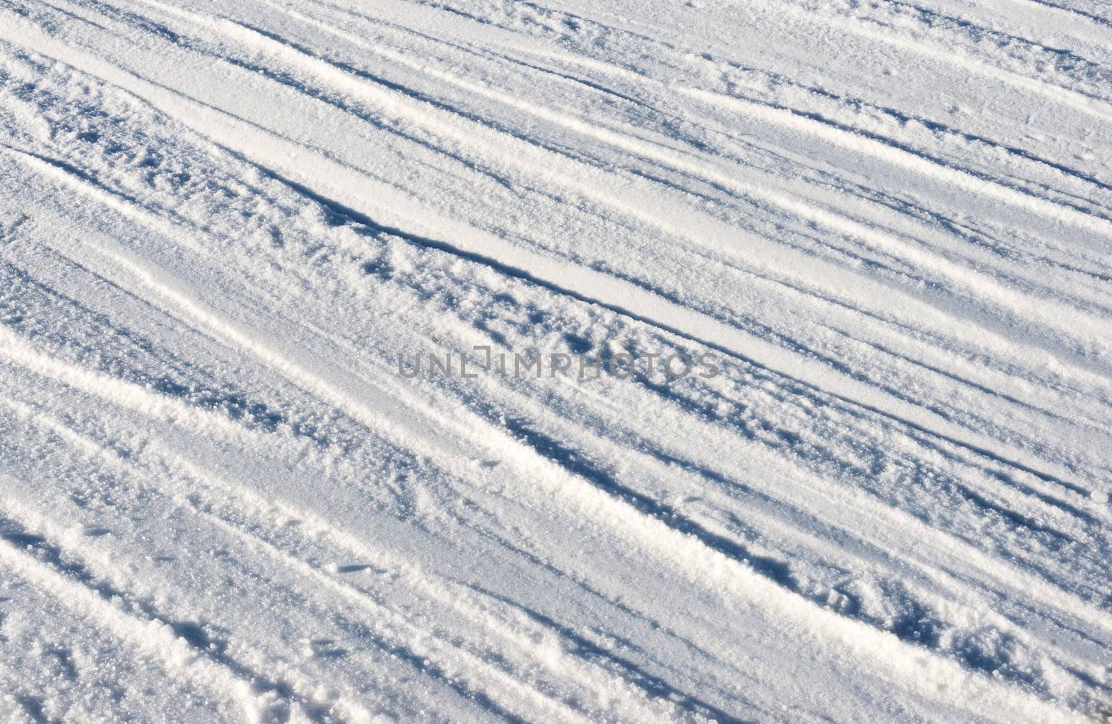 Closeup photo of skis marks on snow slope by DNKSTUDIO