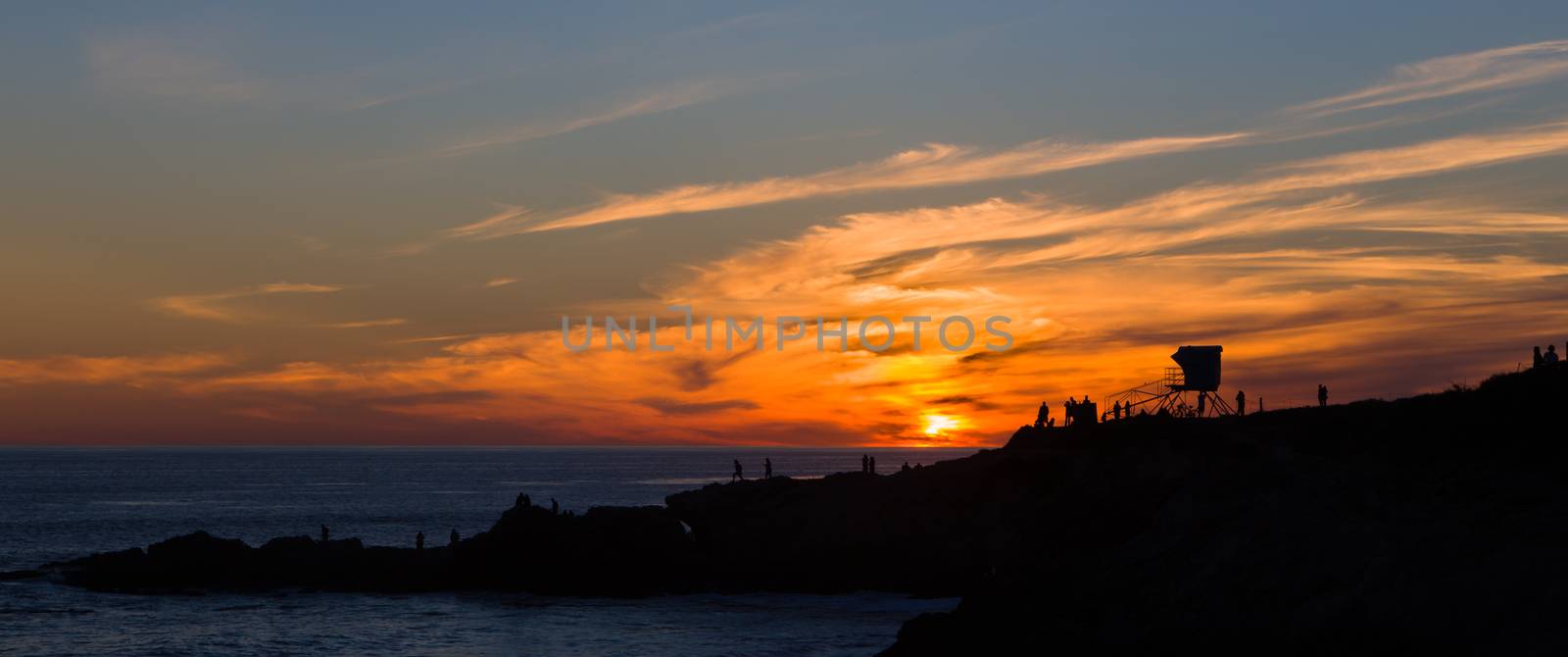 Silhouette of people watching the sun set over the Pacific Ocean at Leo Carillo State Beach
