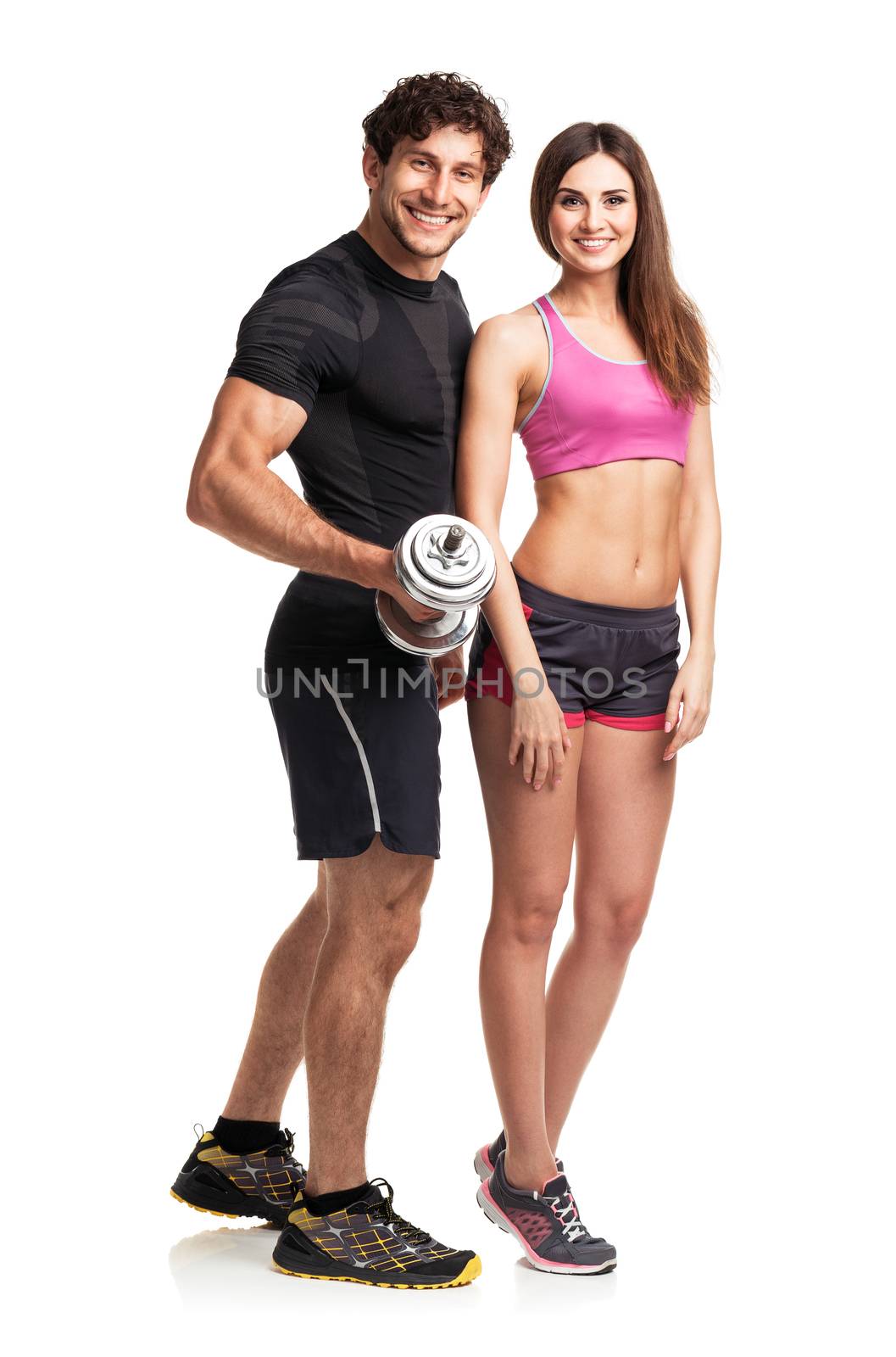 Sport couple - man and woman with dumbbells on the white background