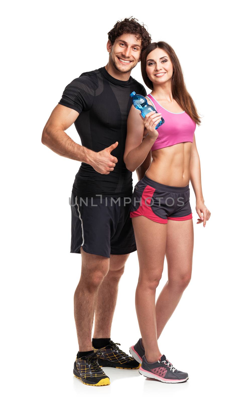 Athletic couple - man and woman with bottle of water on the whit by vlad_star