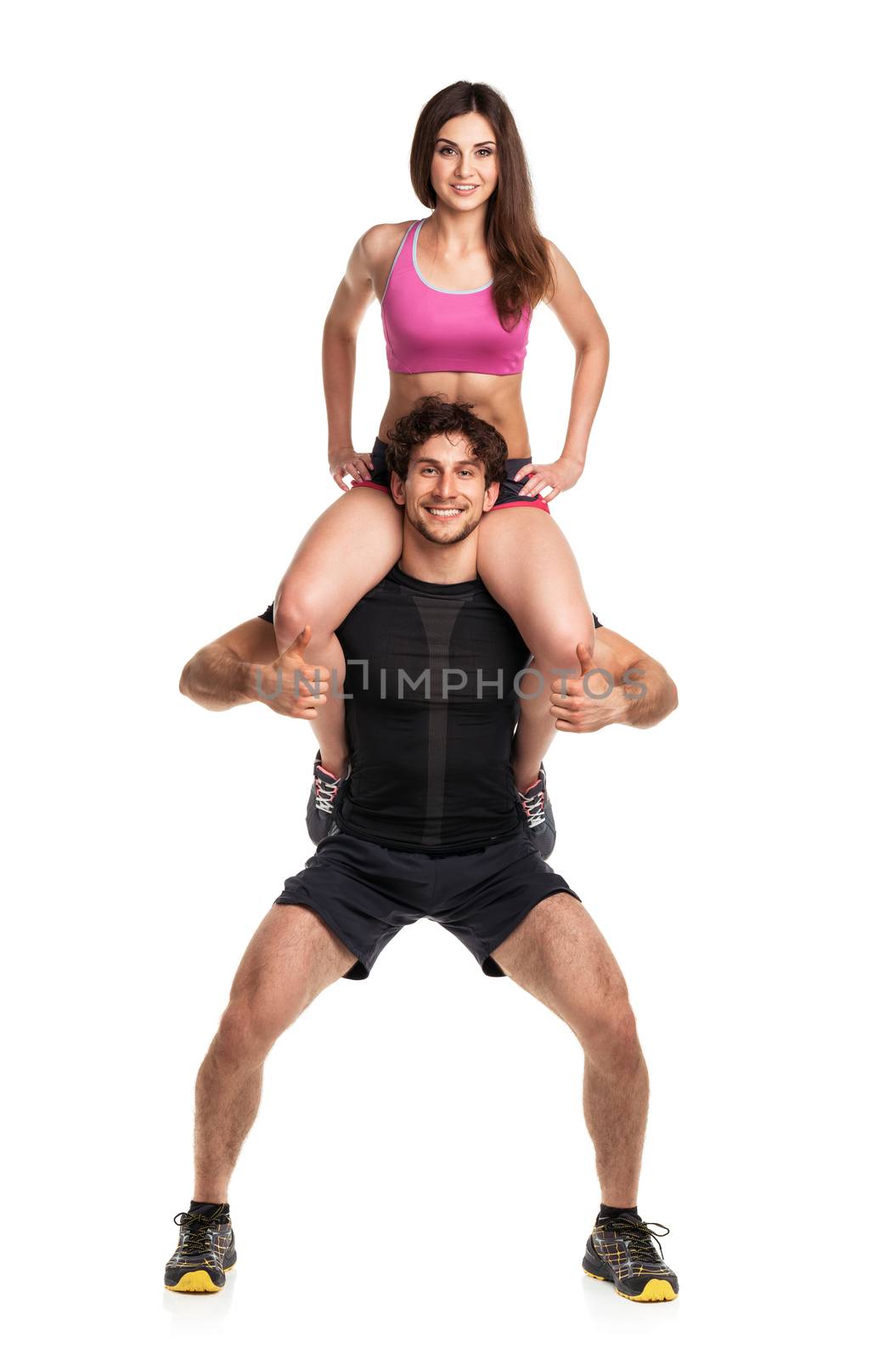 Sports guy holds on shoulder a girl on a white background