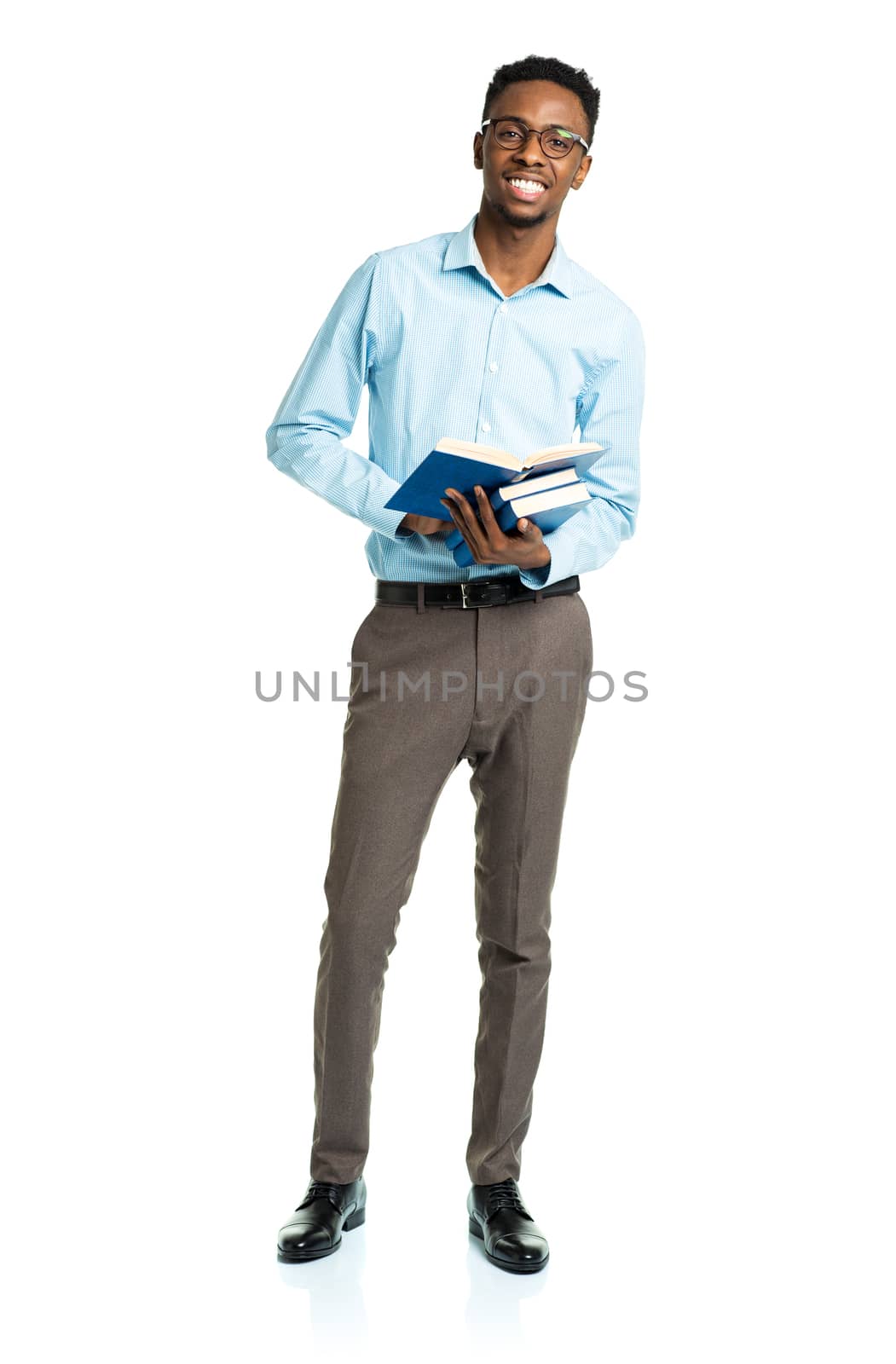 Happy african american college student with books in his hands  standing on white background