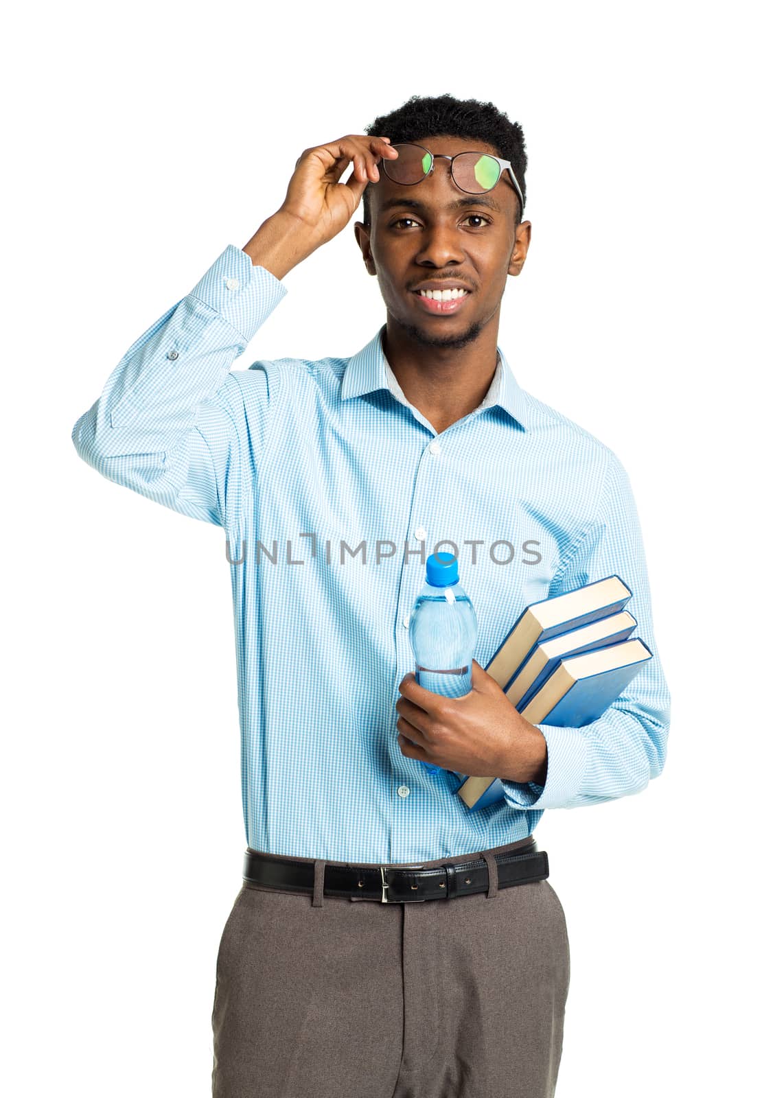 Happy african american college student with books and bottle of water in his hands  standing on white background