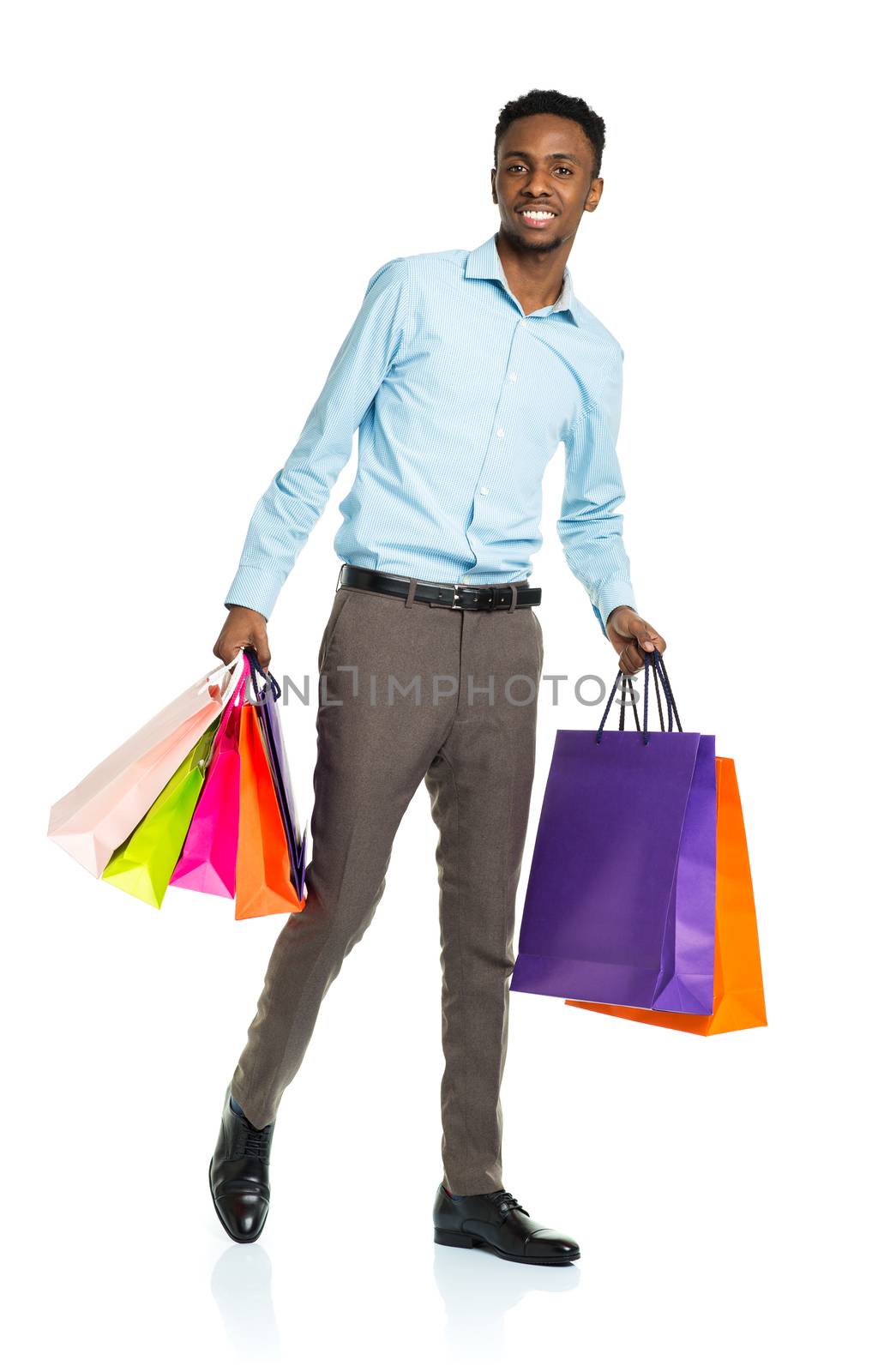 Happy african american man holding shopping bags on white backgr by vlad_star