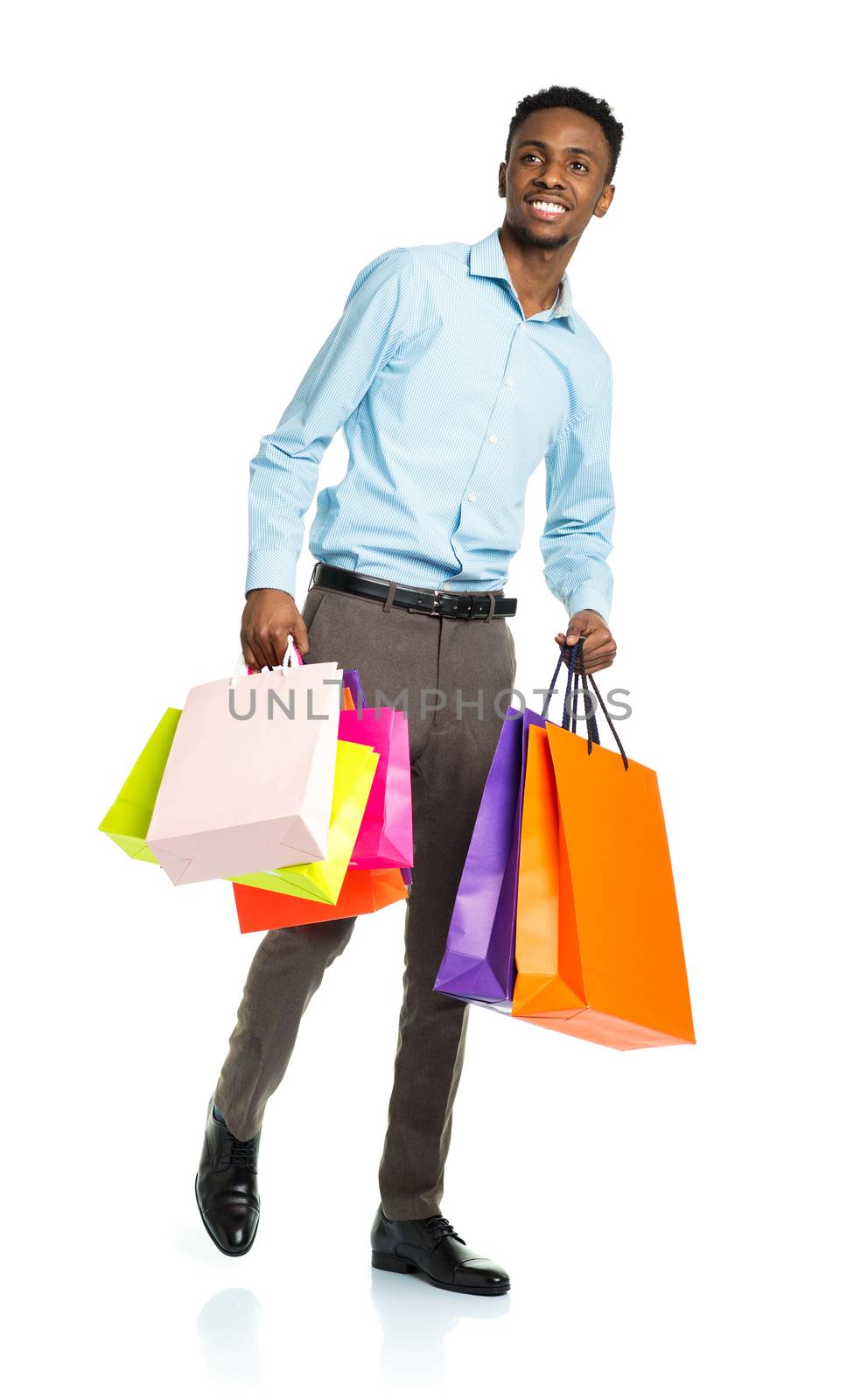 Happy african american man holding shopping bags on white background. Holidays concept