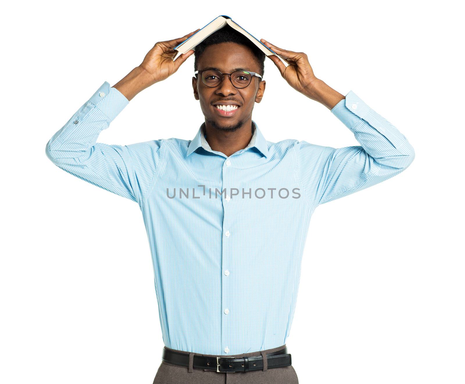 Happy african american college student with book on his head standing on white background