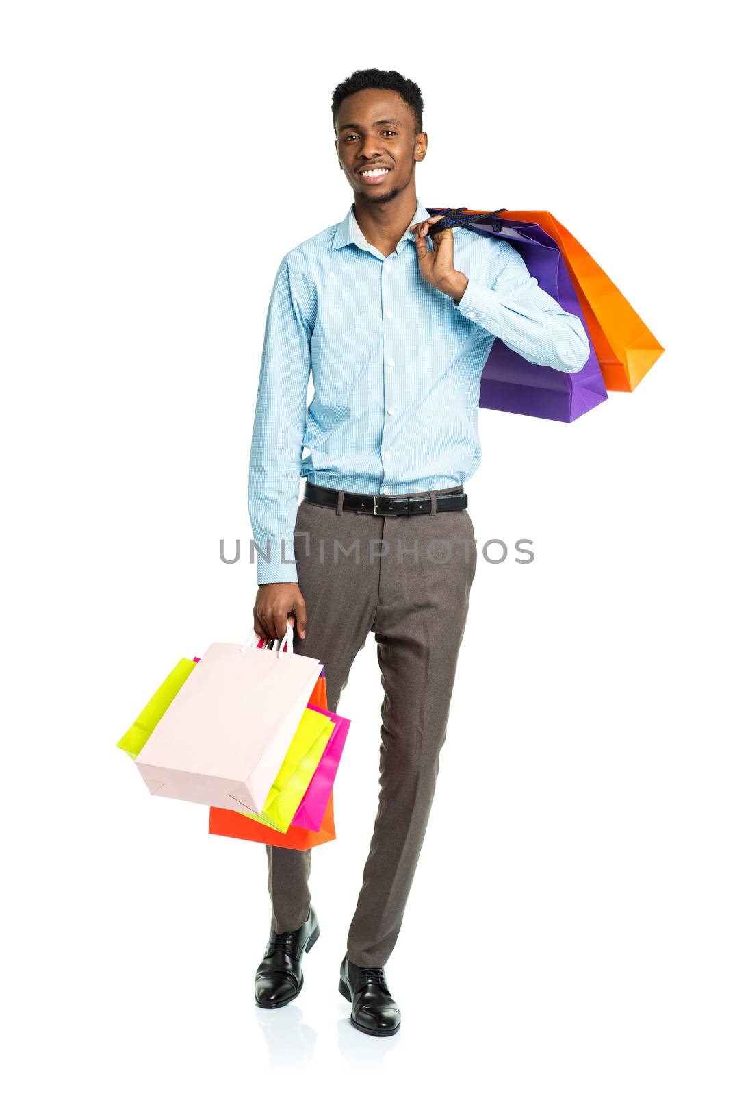 Happy african american man holding shopping bags on white background. Holidays concept