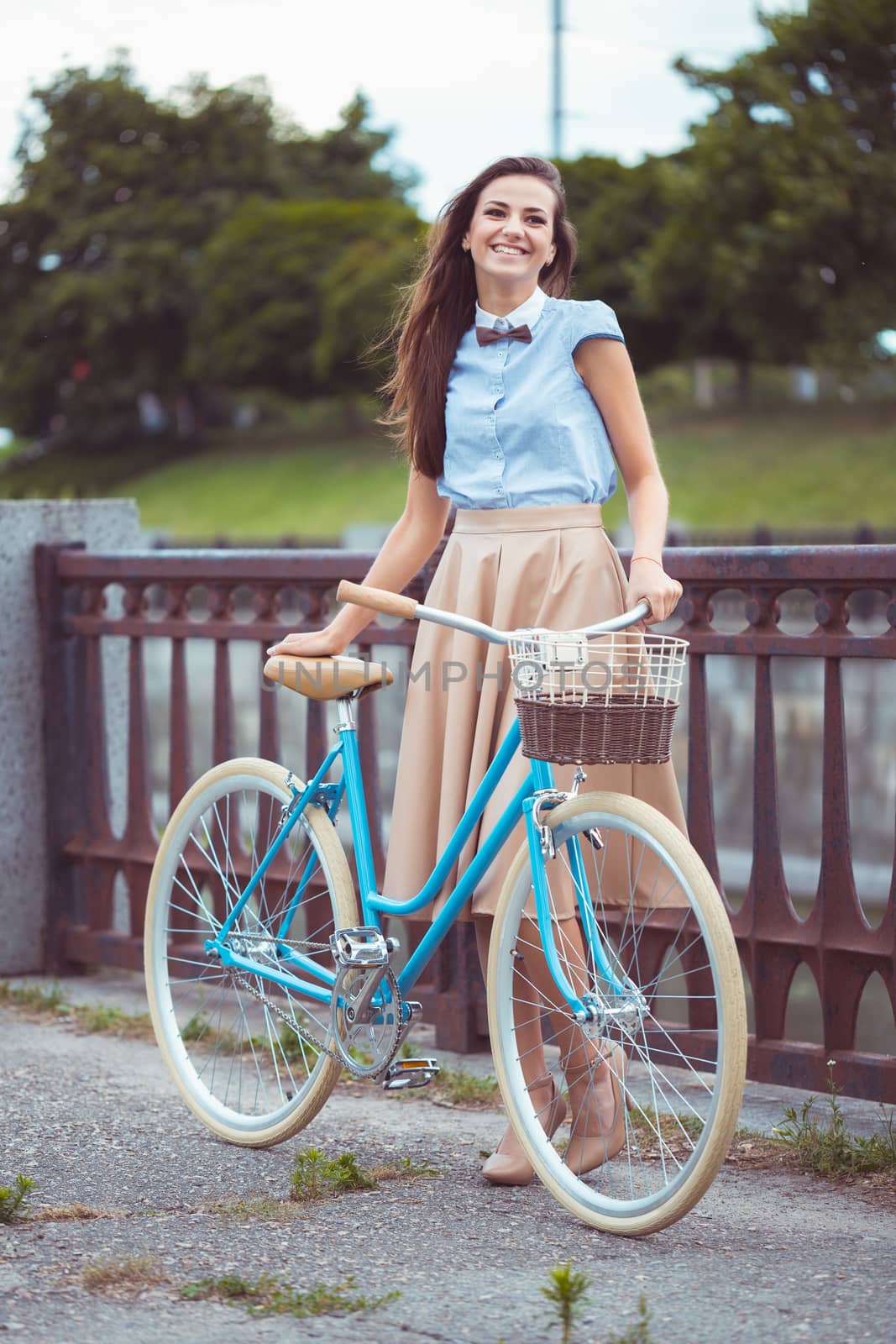 Young beautiful, elegantly dressed woman with bicycle by vlad_star