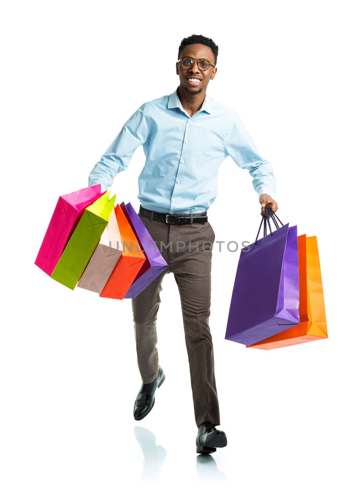 Happy african american man holding shopping bags on white backgr by vlad_star