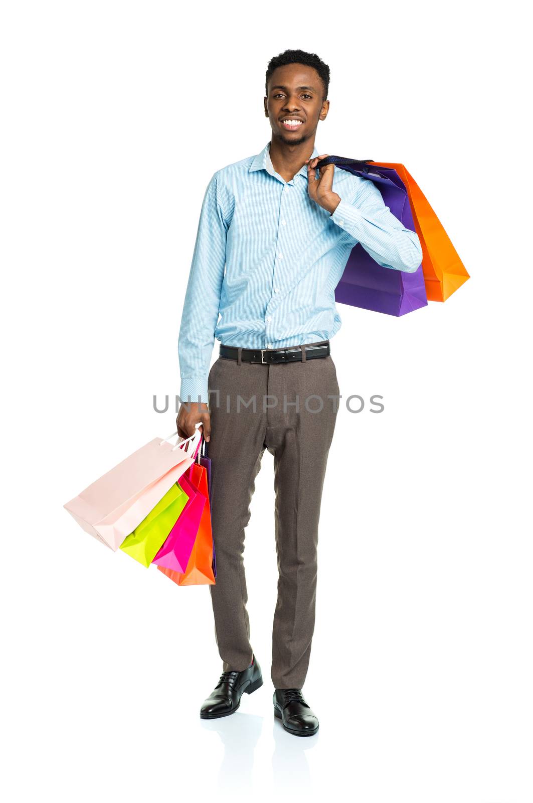 Happy african american man holding shopping bags on white background. Holidays concept