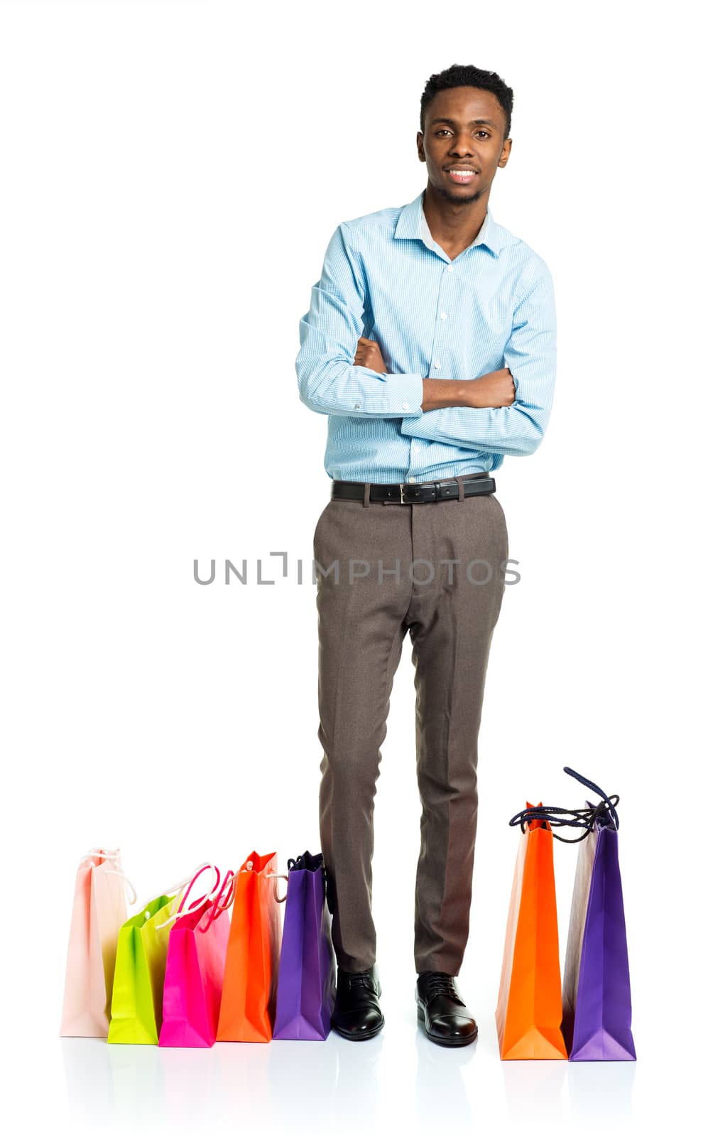 Happy african american man with shopping bags on white background. Holidays concept