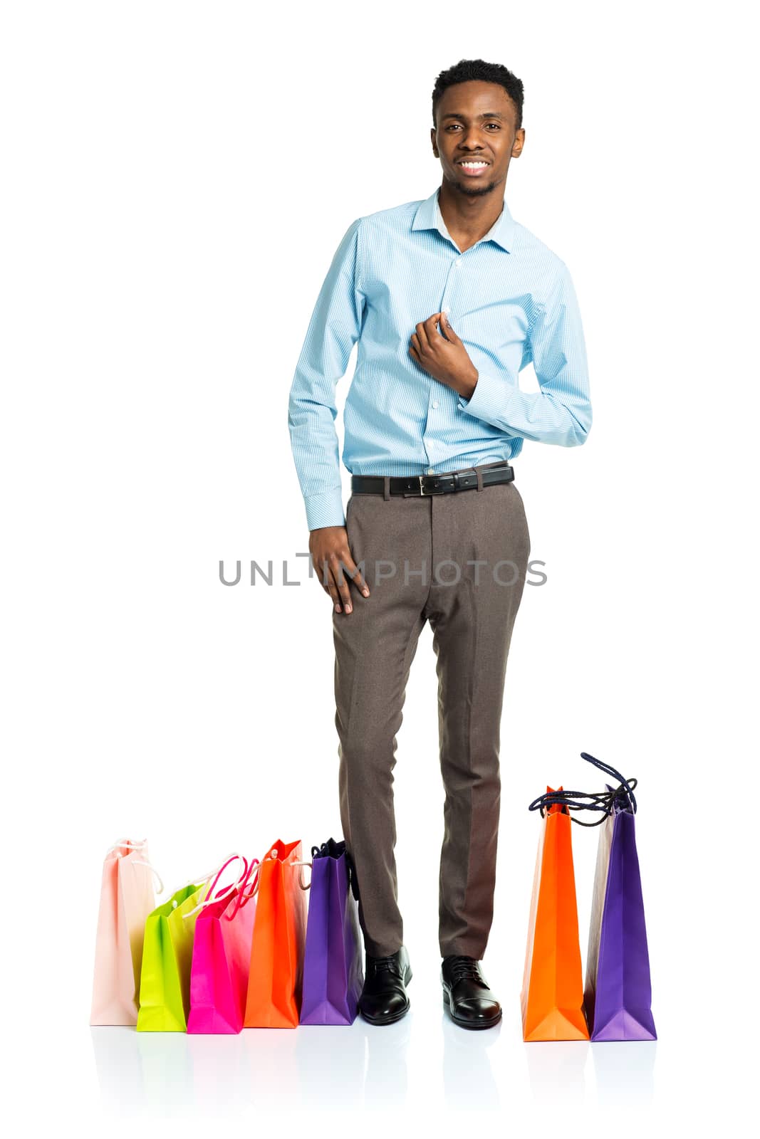 Happy african american man with shopping bags on white background. Holidays concept