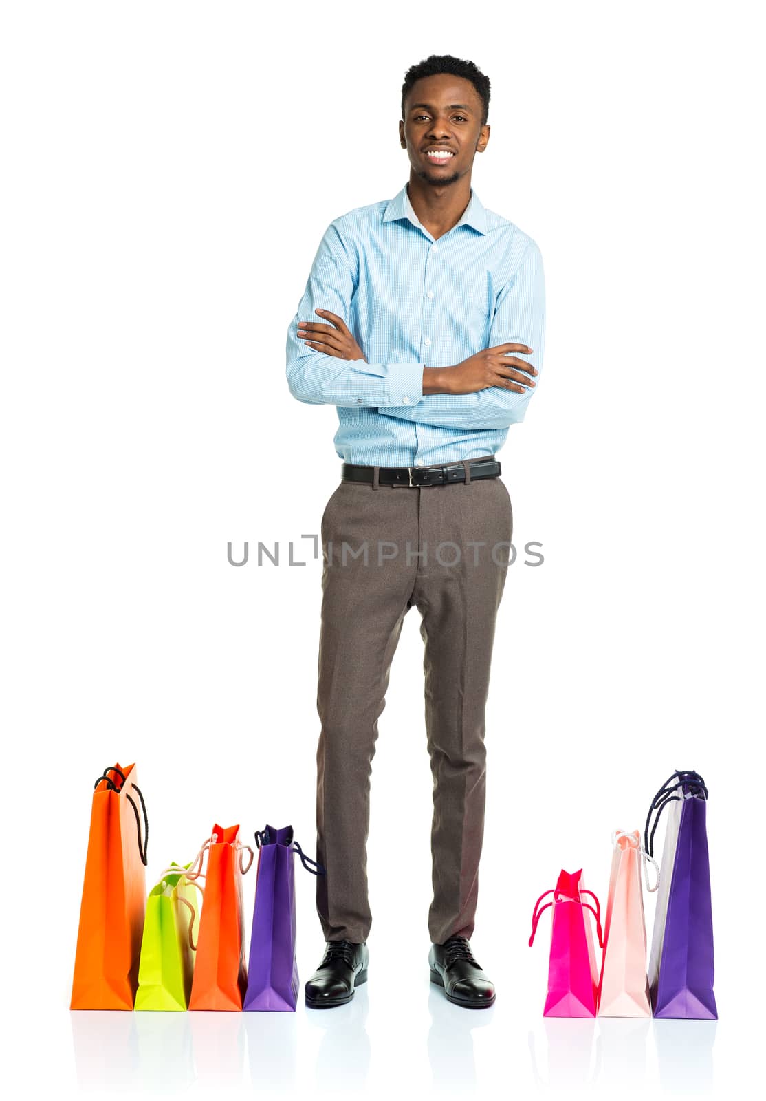 Happy african american man with shopping bags on white background. Holidays concept