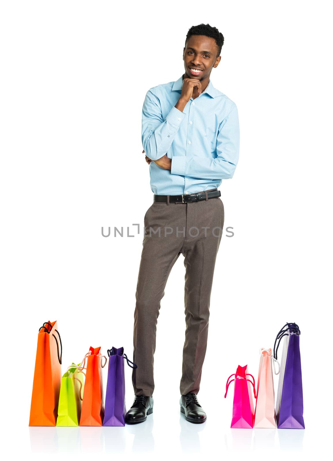 Happy african american man with shopping bags on white background. Holidays concept