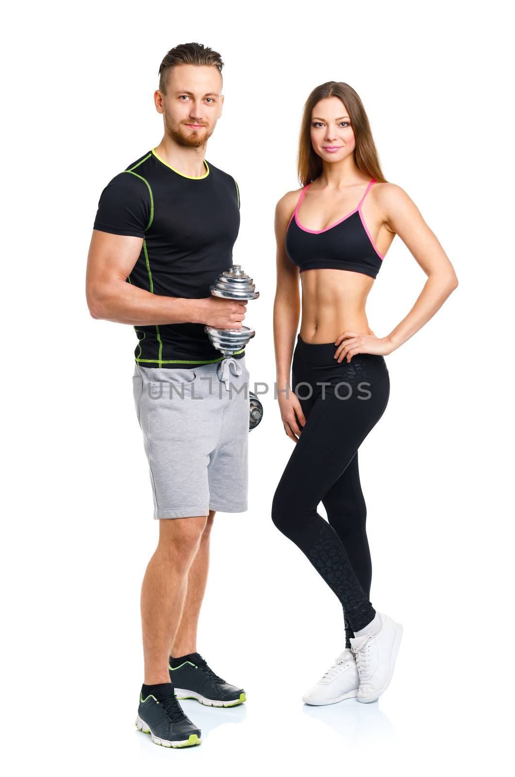 Sport couple - man and woman with dumbbells on the white background