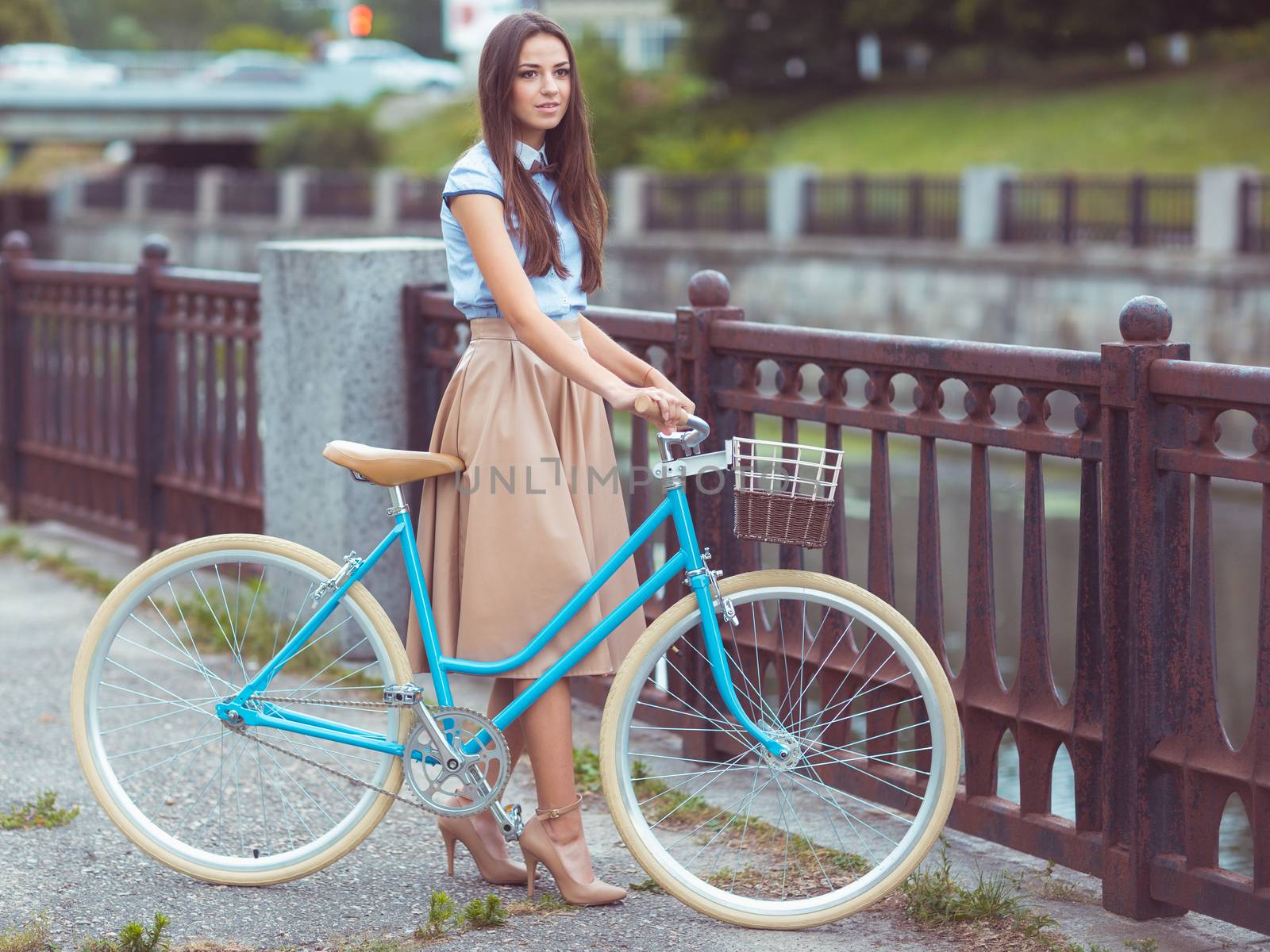 Young beautiful, elegantly dressed woman with bicycle by vlad_star