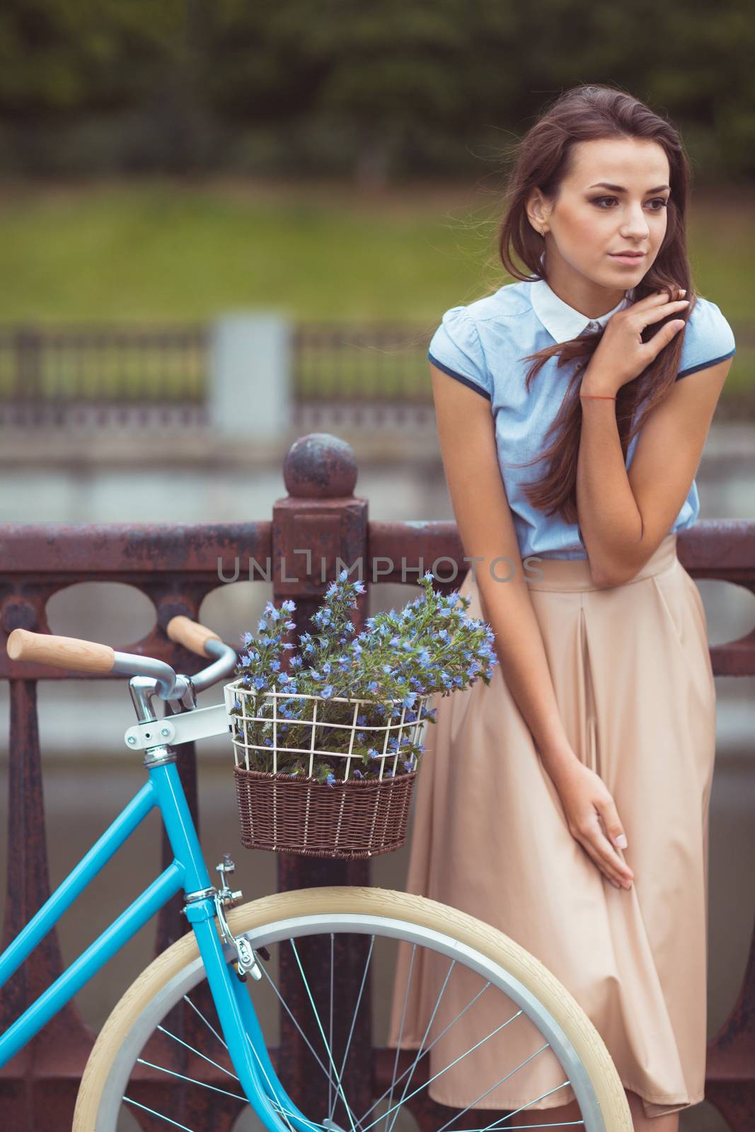 Young beautiful, elegantly dressed woman with bicycle. Beauty, fashion and lifestyle