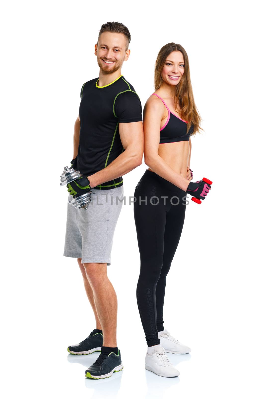 Athletic couple - man and woman with dumbbells on the white by vlad_star