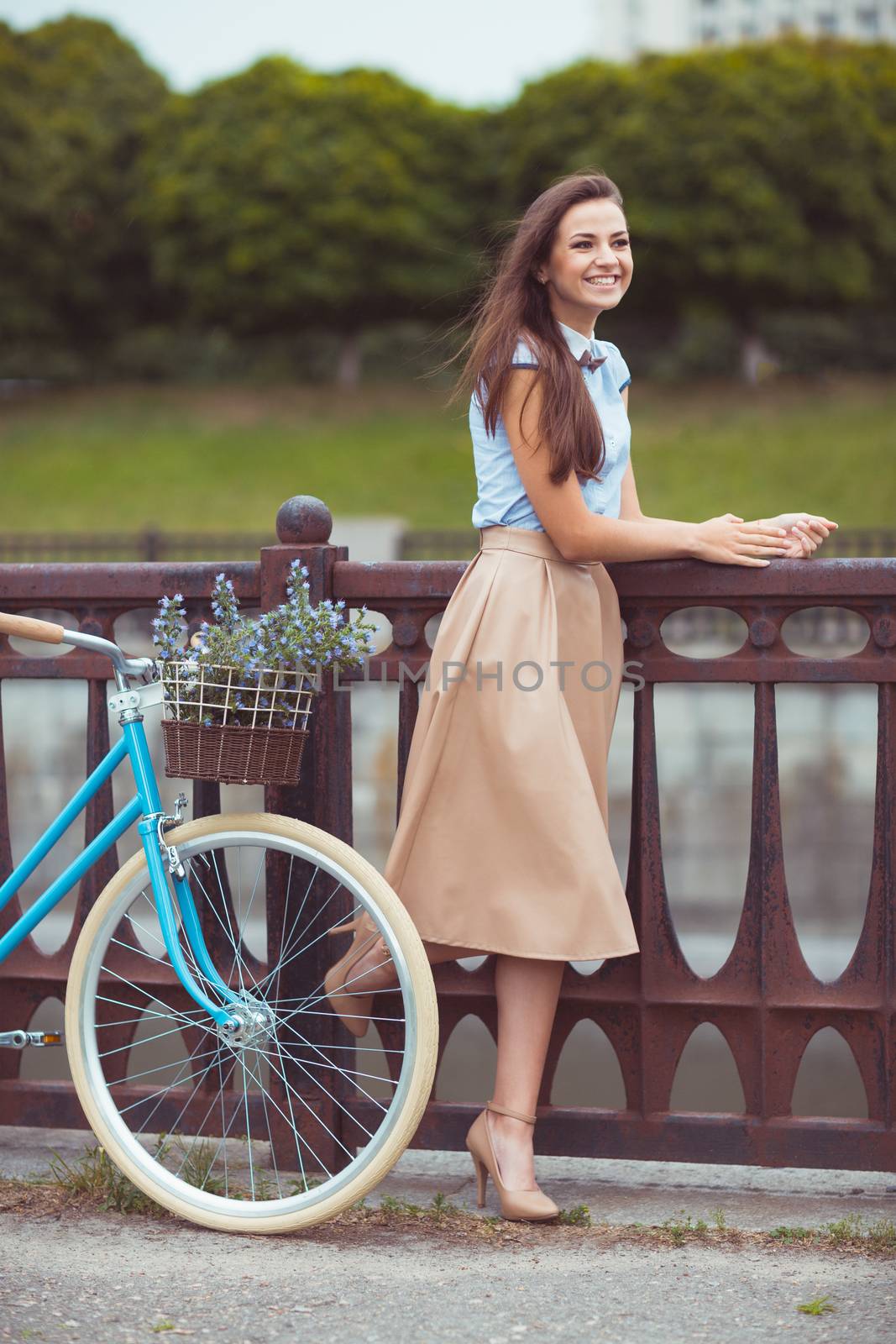 Young beautiful, elegantly dressed woman with bicycle. Beauty, fashion and lifestyle