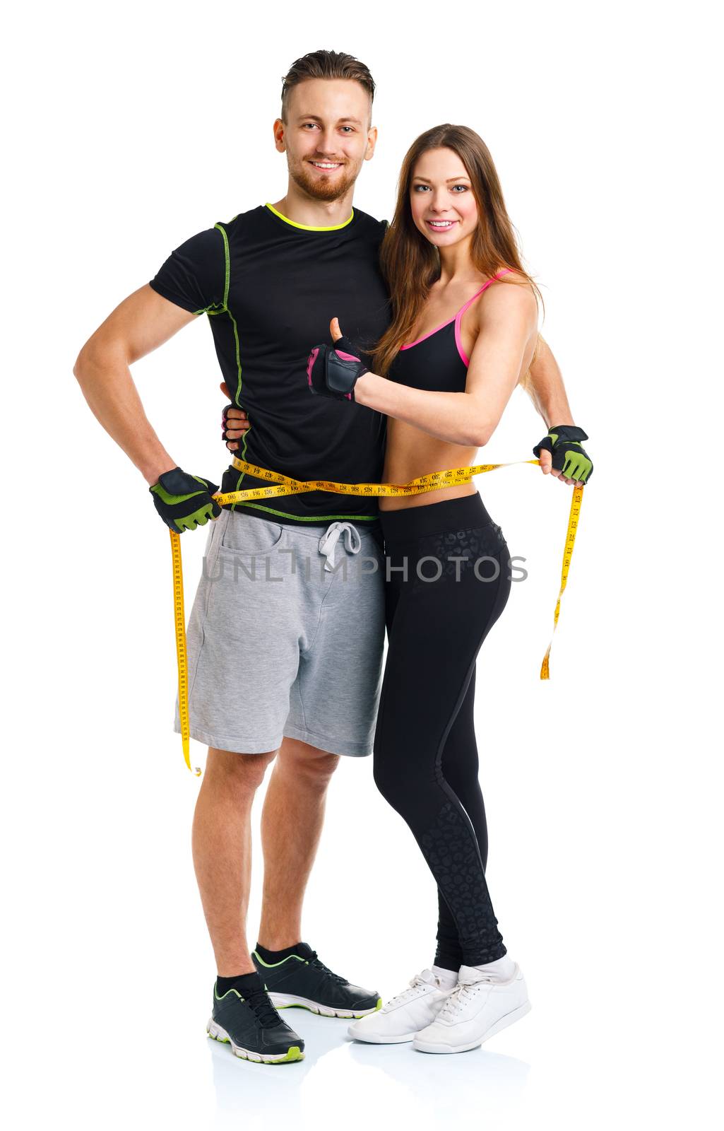 Happy sport couple - man and woman with measuring tape and ginger up on the white background