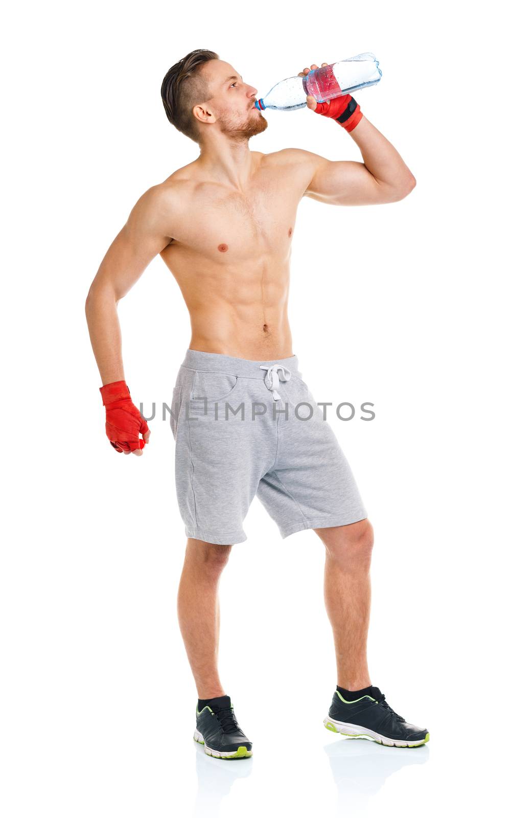 Sport attractive man wearing boxing bandages and drinking fresh water on the white background