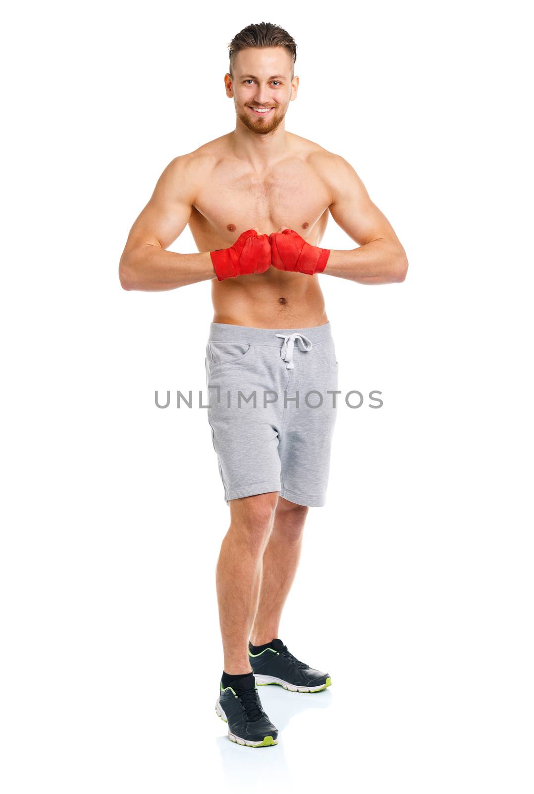 Athletic attractive man wearing boxing bandages on the white background