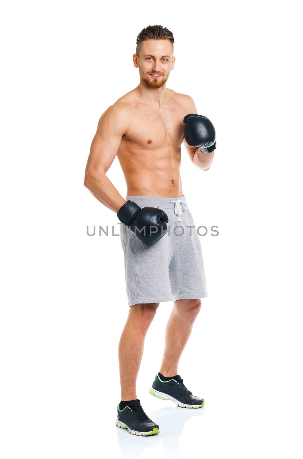 Athletic attractive man wearing boxing gloves on the white background