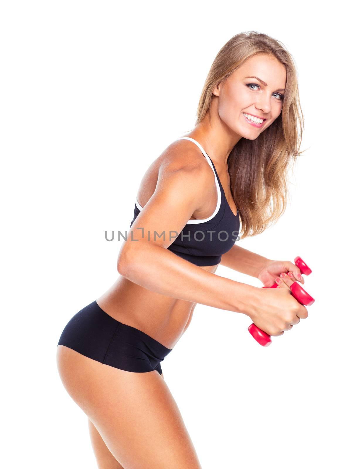 Young sports girl with dumbbells does exercises on a white background