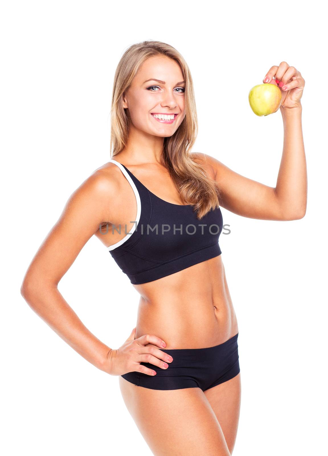 Young smiling girl holding green apple in hand. Fitness woman isolated on white background