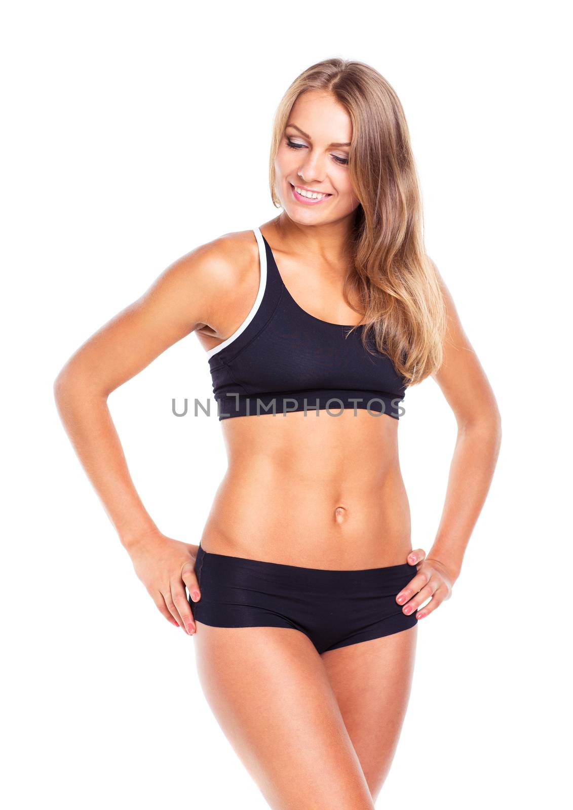 Young sports girl does exercises on a white background