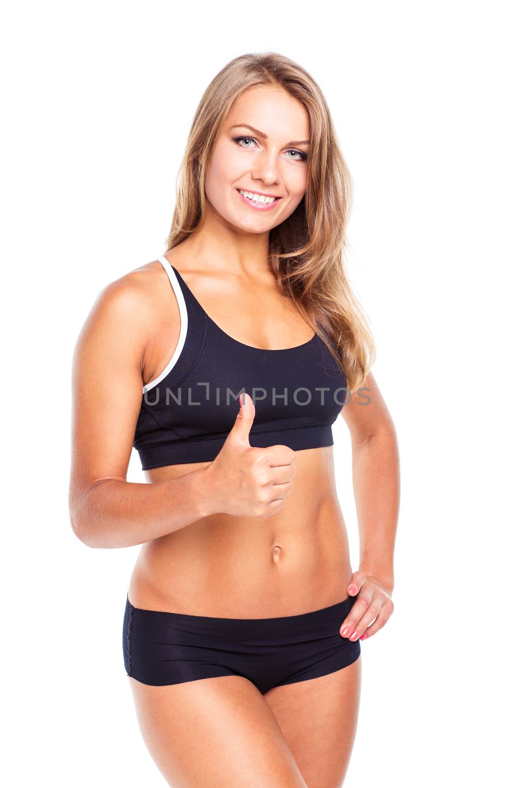 Young athletic girl with a finger up on white background